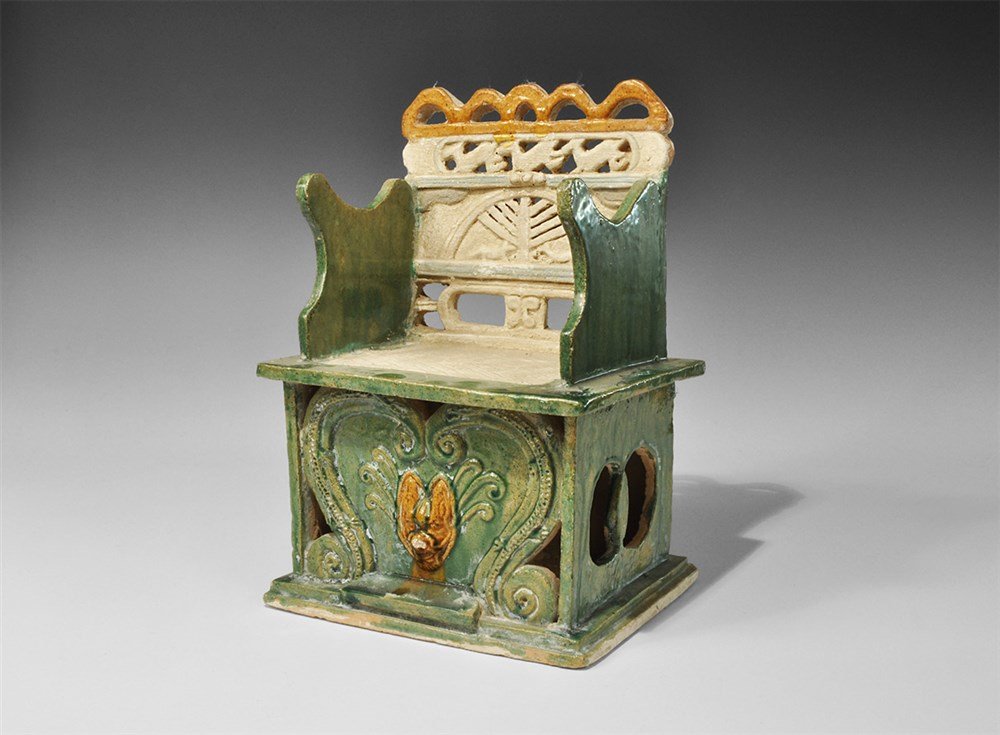 Chinese Ceramic Votive Chair: Ming Dynasty, 1368-1644 AD. A fabricated ceramic votive chair with openwork detail, green glaze to the arms and base, orange to the upper back and central plaque to the base. 2.5 kg, 28 cm (11"). From