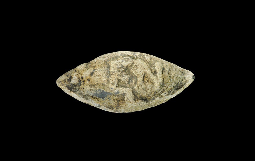 Roman Lead 'LEN' Epigraphic Slingshot: 1st century BC. A cast lentoid shot, round in section, with reserved text 'LEN' to one face for Lentulus, a Roman statesman. Cf. Seaby, p.114 item 5a. 74 grams, 44 mm (1 3/4"). Property of a Middlesex