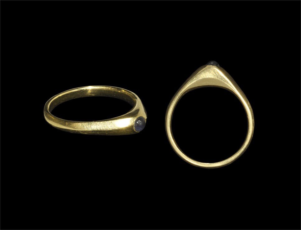 Medieval Gold Bishop's Ring with Sapphire: 14th century AD. A D-section hoop expanding to a pyramidal bezel with inset sapphire cabochon; English workmanship. 4.44 grams, 24 mm (1"). Private collection, Nottinghamshire, UK; acquired late 1980s