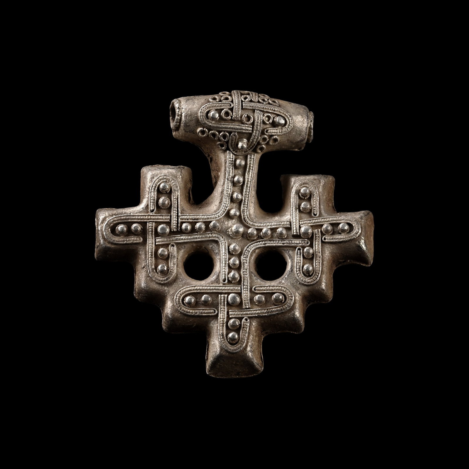 Scandinavian Viking Silver Filigree Tau Cross Pendant: Circa 10th-12th century A.D. Cruciform hollow pendant with applied interlaced granulation to the obverse, filigree borders and scrolled interlaced 'face' design on the suspension bar. Cf. Franceschi, 