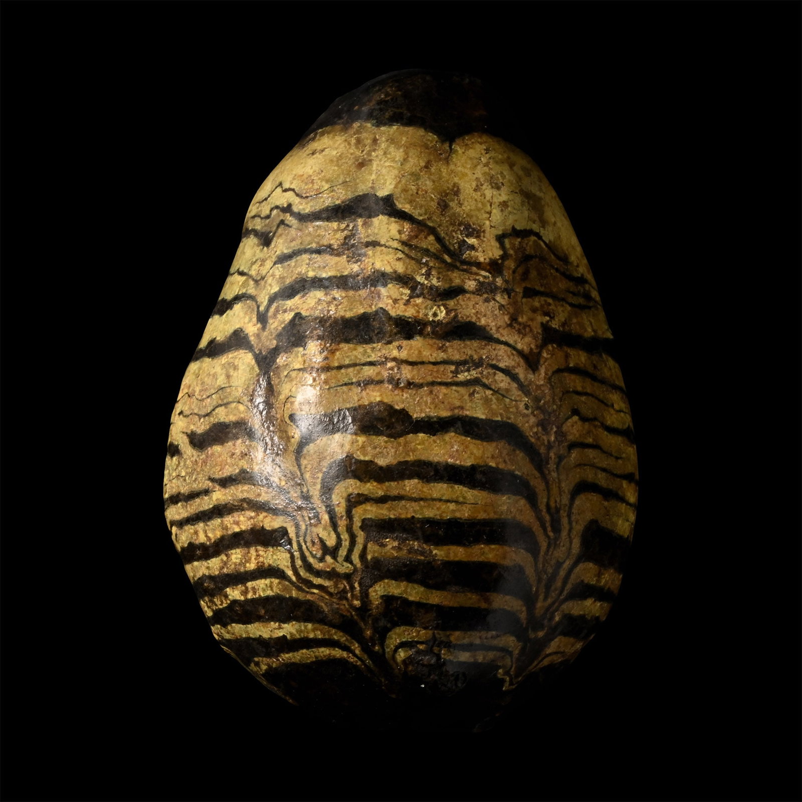 Viking Glazed 'Resurrection Egg': Circa 9th-10th century A.D. A glazed hollow ceramic egg with a hole to the underside and a smaller pellet inside; regular, dragged yellow lines to the outer face. See Fornvännen Journal Of Swedish An