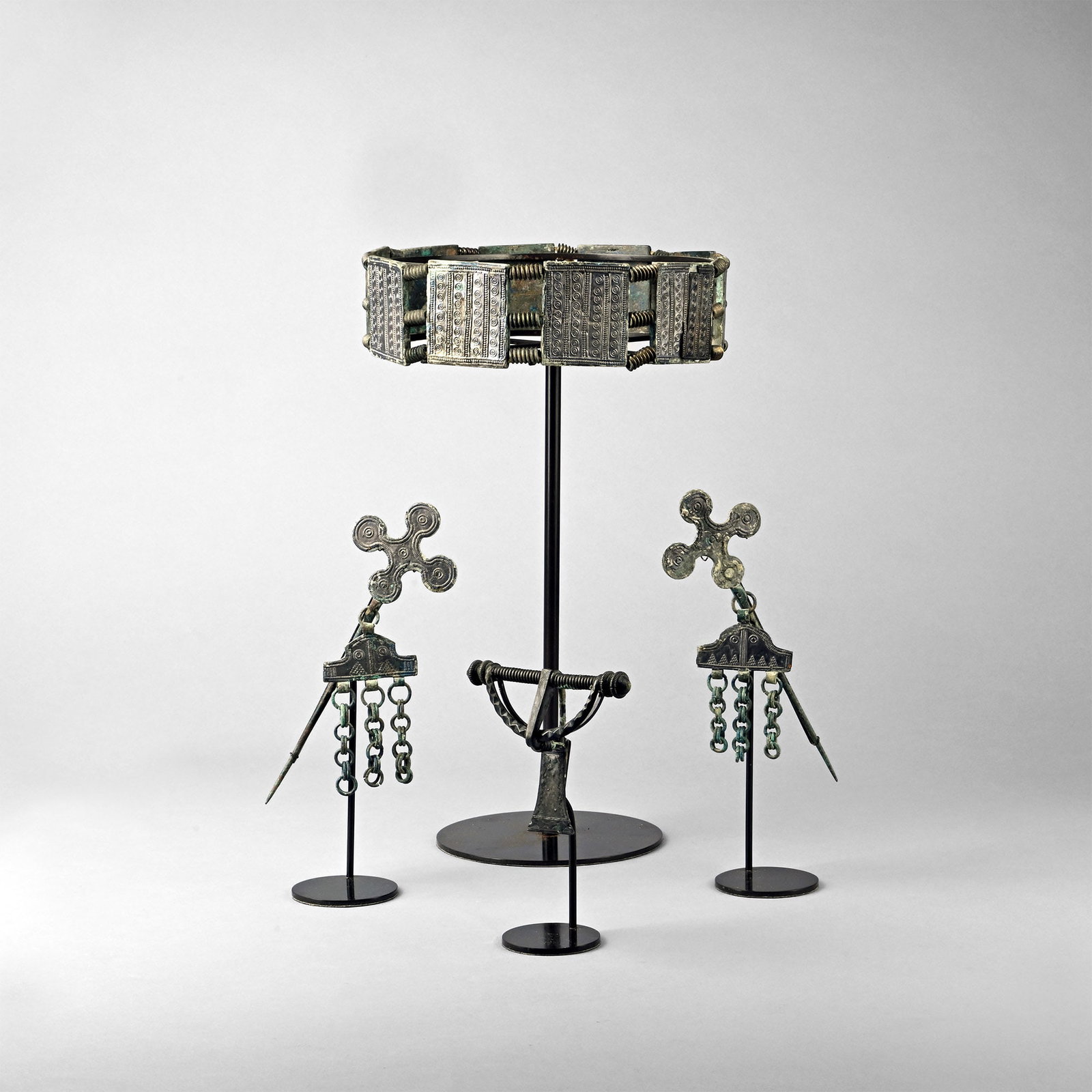Viking Period Ornate Crown with Brooch and Pin Set: Circa 8th-9th century A.D. Comprising: a restrung headdress formed as ten square panels, each with vertical bands of pellets framing four columns of ring-and-dot ornament, with interstitial groups of 
