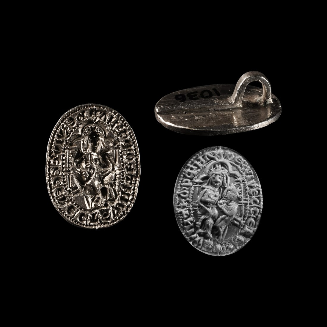 Medieval Silver Seal Matrix for the Rector of Swainsthorpe Magna: Early 15th century A.D. An ellipsoid seal matrix with a strap to the reverse; incuse motif of crowned Mary seated on a throne with infant Jesus; legend to the edge within pelletted borders '*hERVIV’