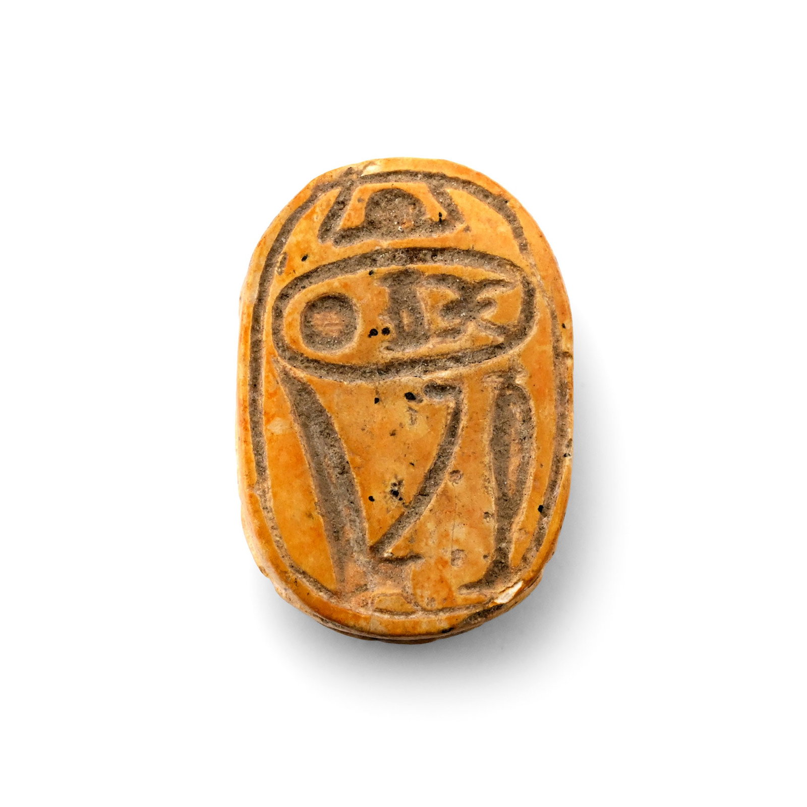 Egyptian Yellow Steatite Scarab with Cartouche: New Kingdom, 18th Dynasty, 1550-1292 B.C. Incised anatomical detailing on the body, underside with a cartouche of Pharaoh Thutmose III, Red crown, hes-vase and sun disc. 1.06 grams, 14 mm (1/2 in.). [