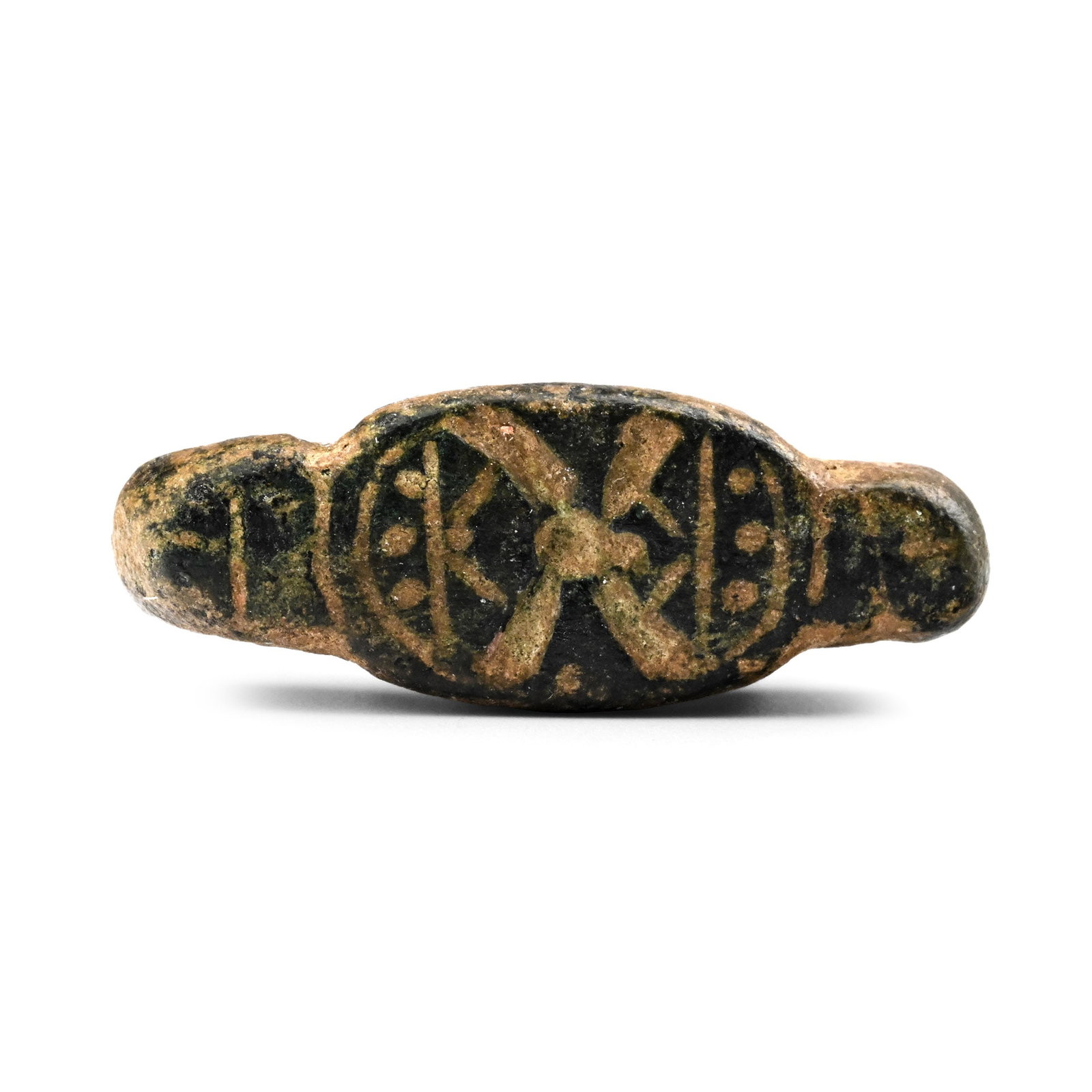 Phoenician Bronze Seal Pendant: Late 1st millennium B.C. Formed as a ribbed lop with short neck, ellipsoid plaque with incuse saltire and pellets. 16.35 grams, 27 mm wide (1 in.). From the collection of a gentleman, acquired on the 