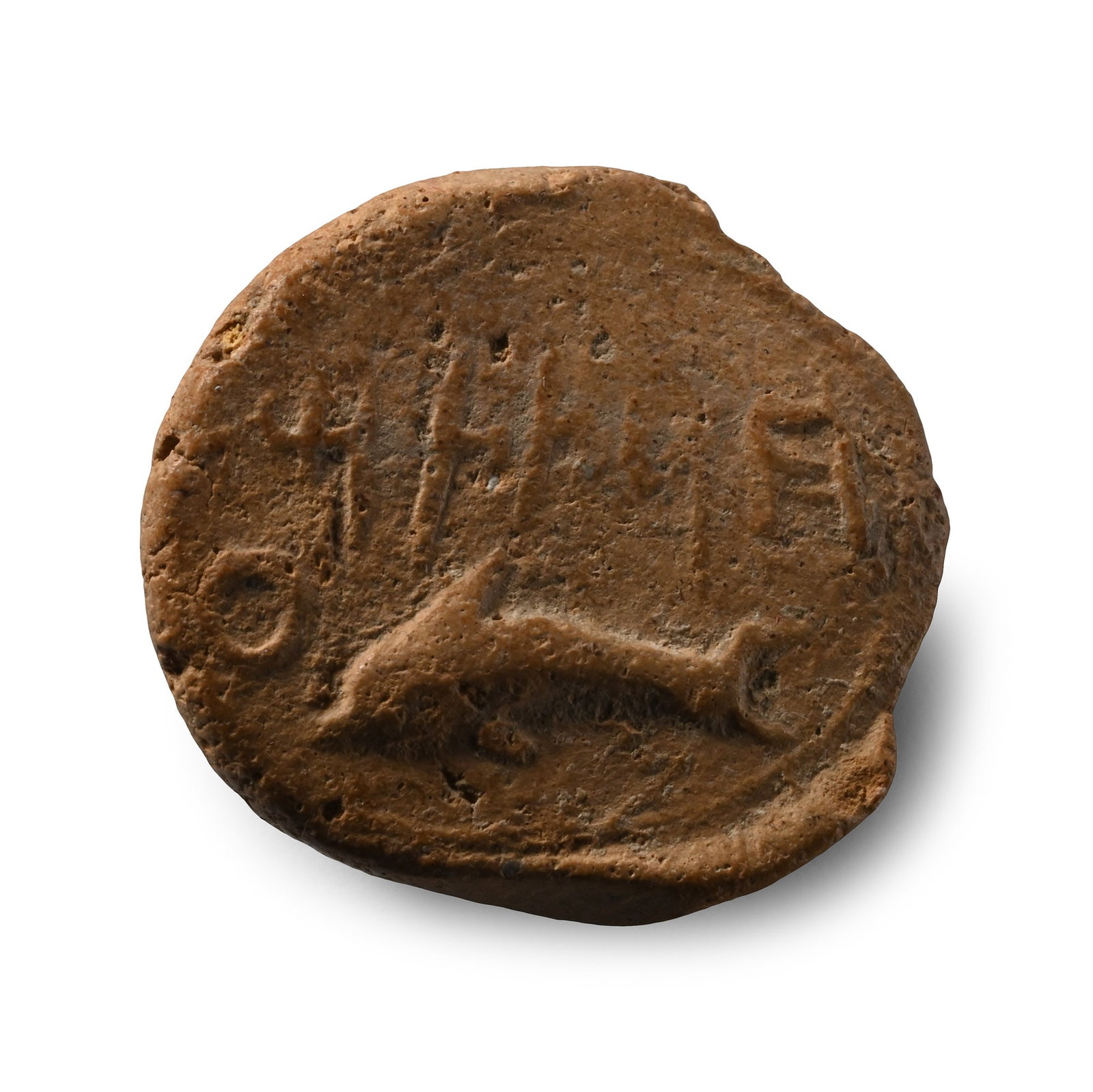Phoenician Terracotta Bulla with a Dolphin: 5th century B.C. Plano-convex in profile with impressed dolphin and legend. 1.05 grams, 17.71 mm (5/8 in.). (For this specific lot, 5% import VAT is applicable on the hammer price.) Acquired in 1994. 