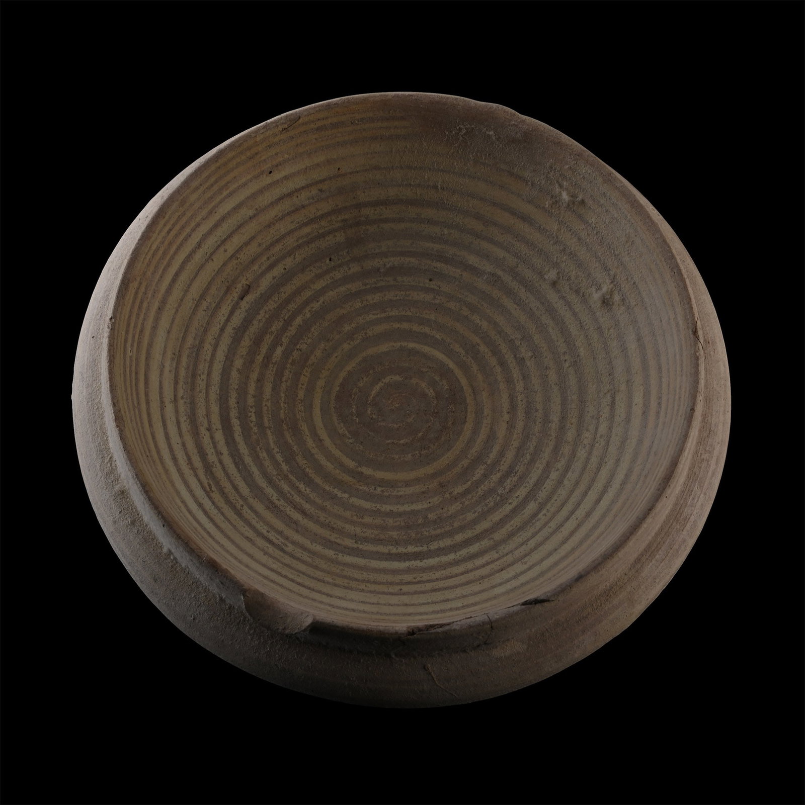 Phoenicio-Punic Terracotta Mortarium: Circa 100 B.C. Comprising a wide, shallow body and a shallow rim, a curved flange below the rim, and spiral decoration on the inside. 620 grams, 21 cm (8 1/4 in.). [No Reserve] From the private collec