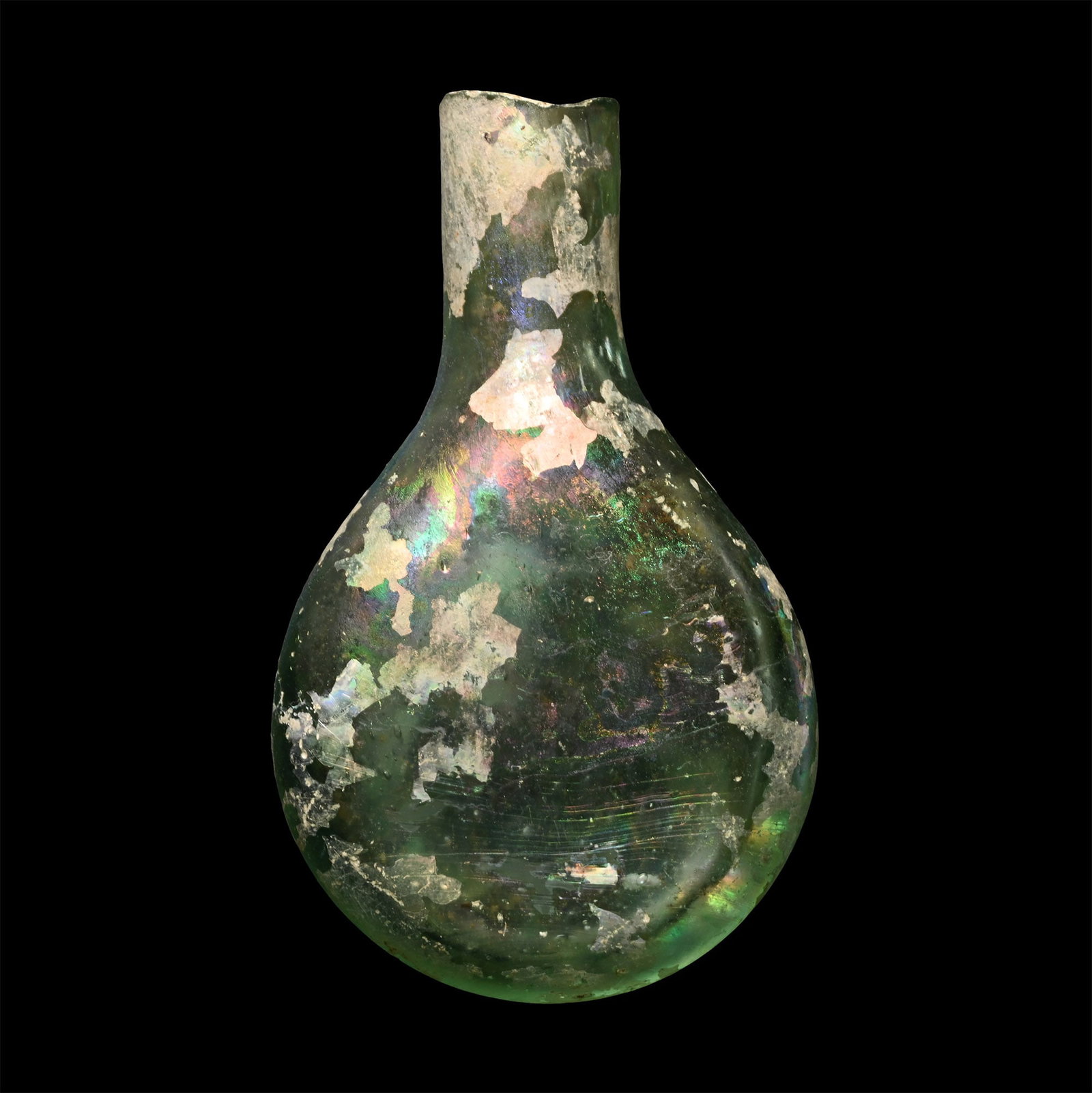 Roman Green Glass Perfume Flask: 1st-4th century A.D. Piriform in plan with flatted body; iridescent surface Cf. for similar The Metropolitan Museum, New York, item 74.51.67, in Lightfoot, C. S., The Cesnola Collection of Cypriot Art