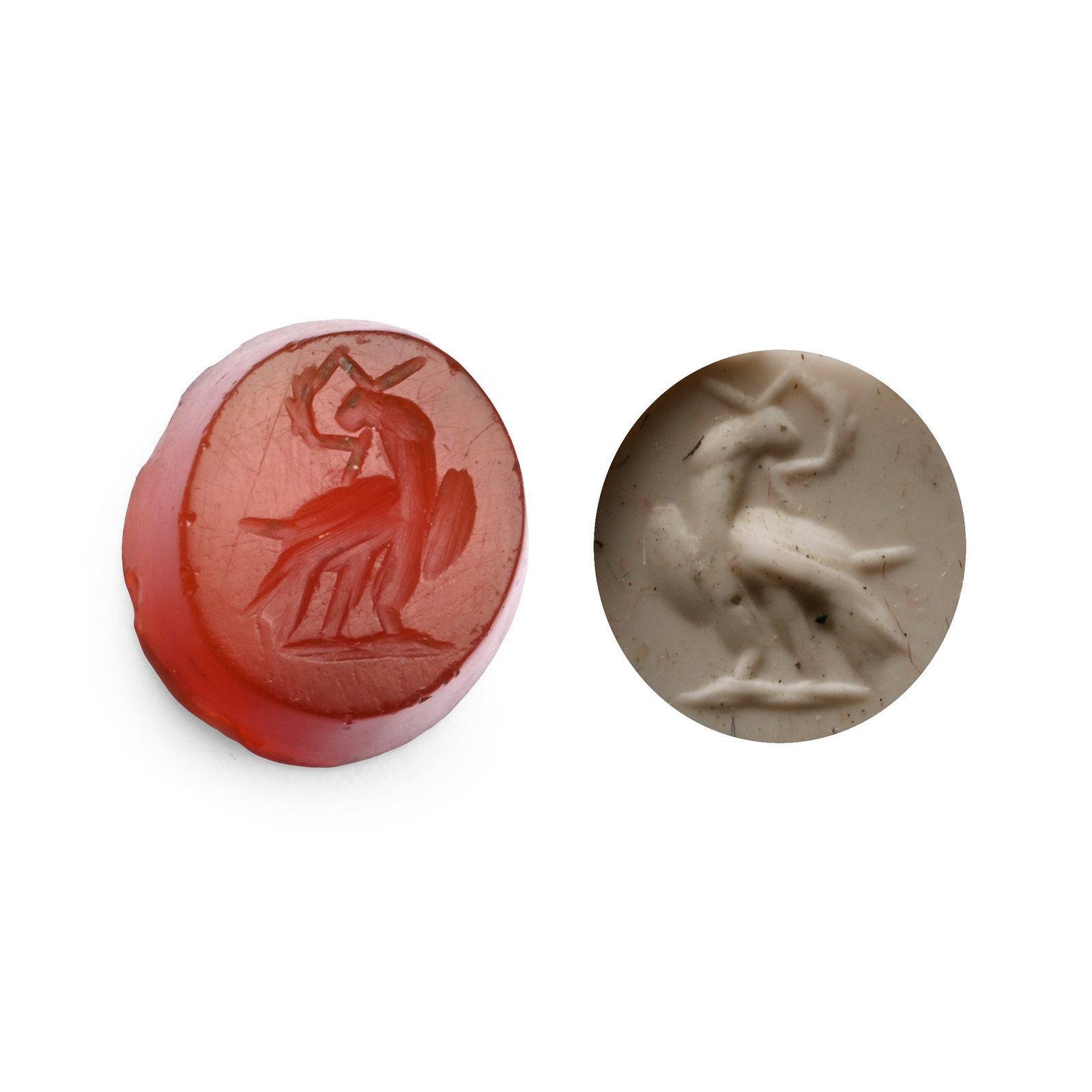 Roman Carnelian Gemstone with Eagle: 2nd-3rd century A.D. With an intaglio eagle standing with its head turned and a wreath in its beak; supplied with a museum-quality impression. 0.97 grams, 11.14 mm (3/8 in.). [No Reserve] From the pri