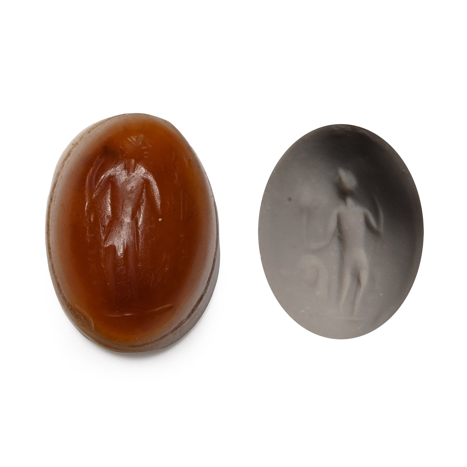Eastern Roman Chalcedony Gemstone with Standing Figure: Circa 2nd-3rd century A.D. Plano-convex in section with incuse standing figure with arms raised, objects in the field, legend beside the lower leg. 1.88 grams, 15.98 mm (5/8 in.). [No Reserve] From th