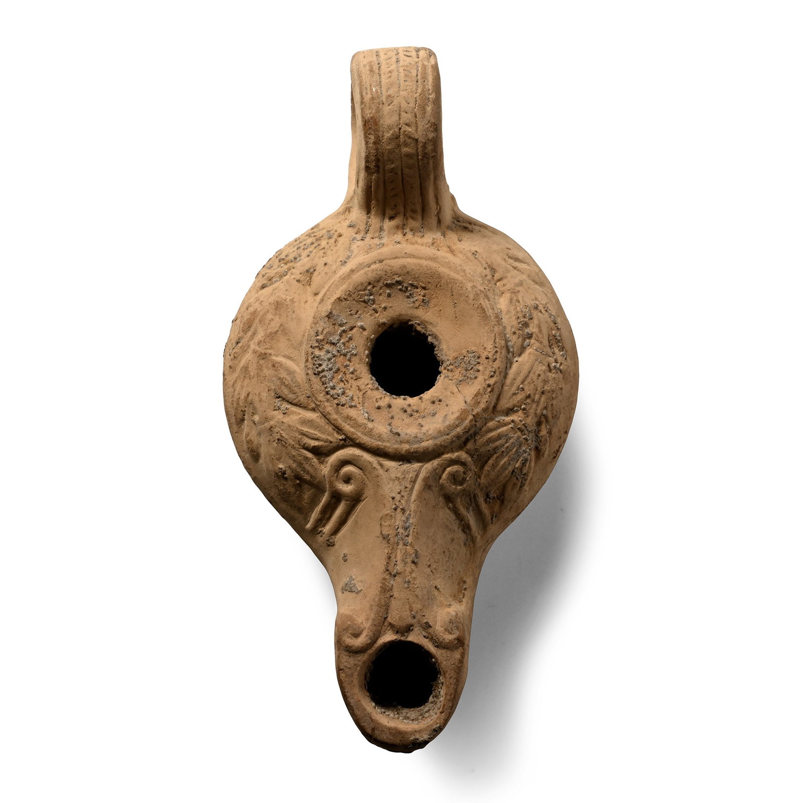 Roman Looped Terracotta Oil Lamp: Circa 1st century A.D. Rounded body with low-relief wreath decoration, volutes on the nozzle, faux-braid decoration on the loop handle and a rosette at the base. 44.49 grams, 10.4 cm (4 in.). [No Rese