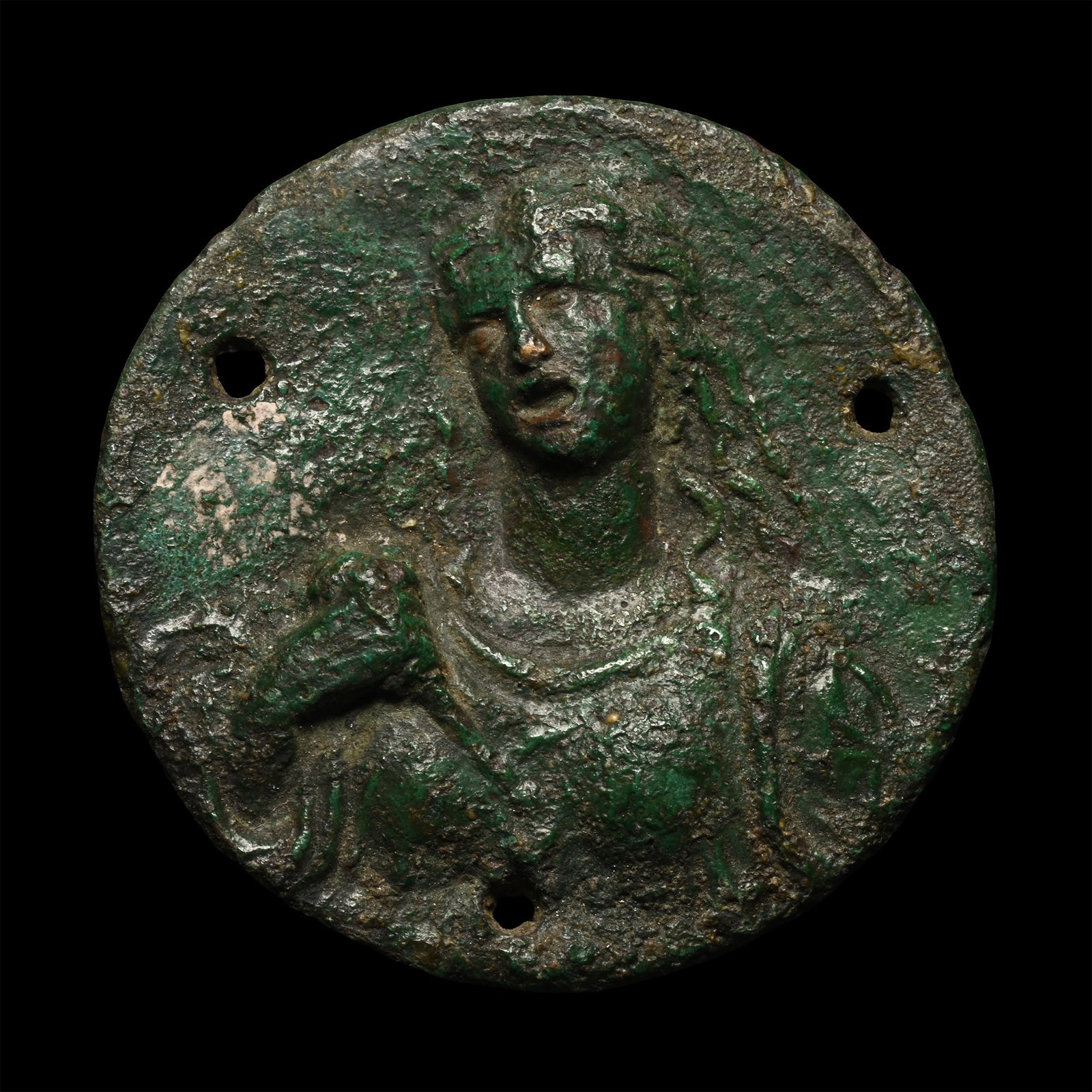 Roman Bronze Plaque of a Goddess: 2nd-3rd century A.D. Flat-section disc with three attachment points; low-relief bust of a female with long flowing hair, distaff in one hand; possibly Nona. 34.13 grams, 49.82 mm (2 in.). [No Reserve]