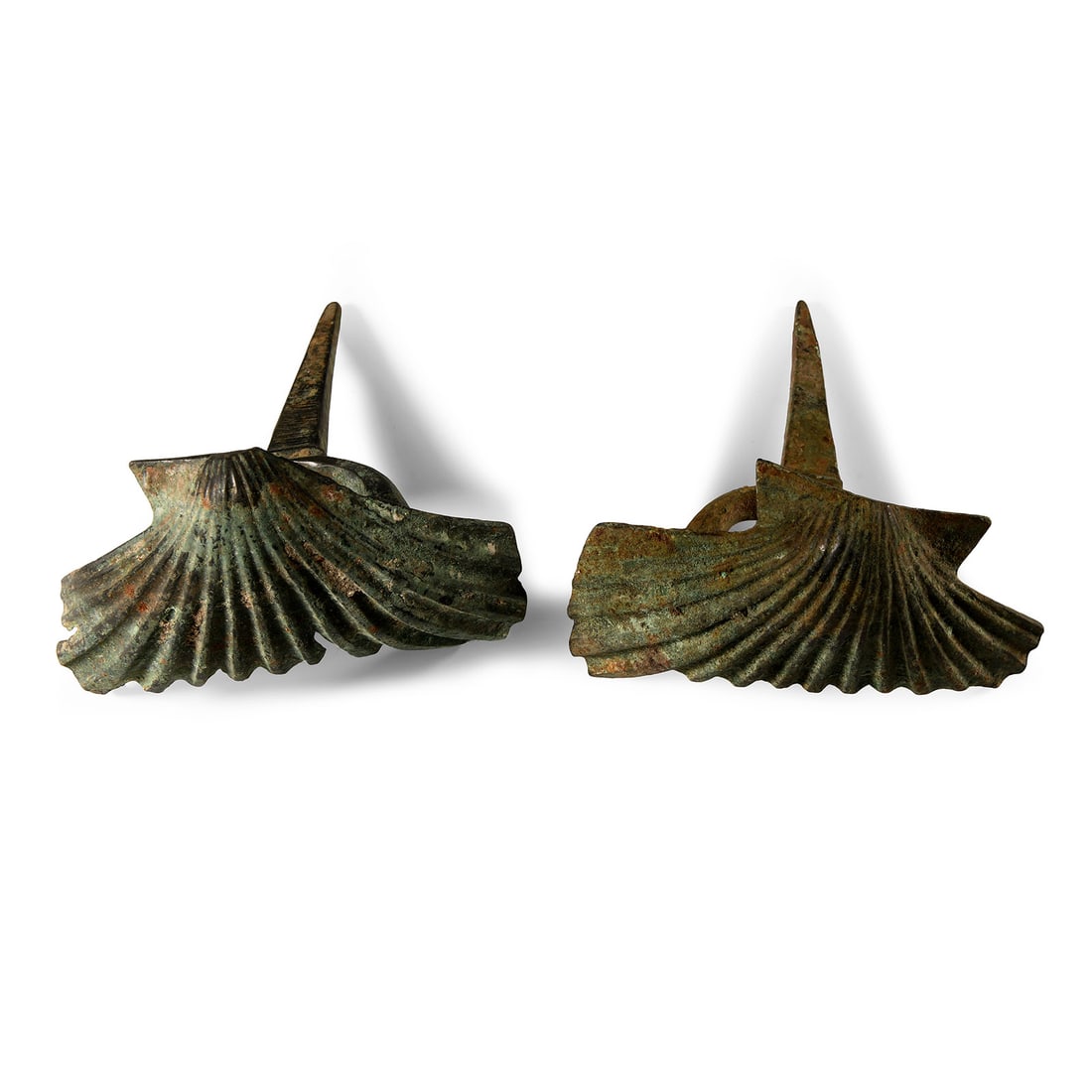 Roman Bronze Scallop Shell 'Door Key' Pair: 2nd-3rd century A.D. Each composed of shell-shaped body with a D-shaped lug to reverse, the lug with tapering spike to the centre. Cf. Boucher, S., Inventaire des Collections Publiques Françaises - 1