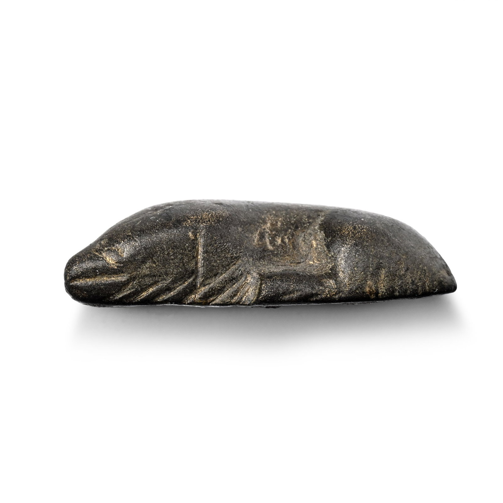 Roman Bronze Sleeping Dog Statuette: 3rd-4th century A.D. Modelled in the round with the head resting on the extended forepaws. 6.04 grams, 23.7 mm (7/8 in.). [No Reserve] From the private collection of a European gentleman (1942-2024), 