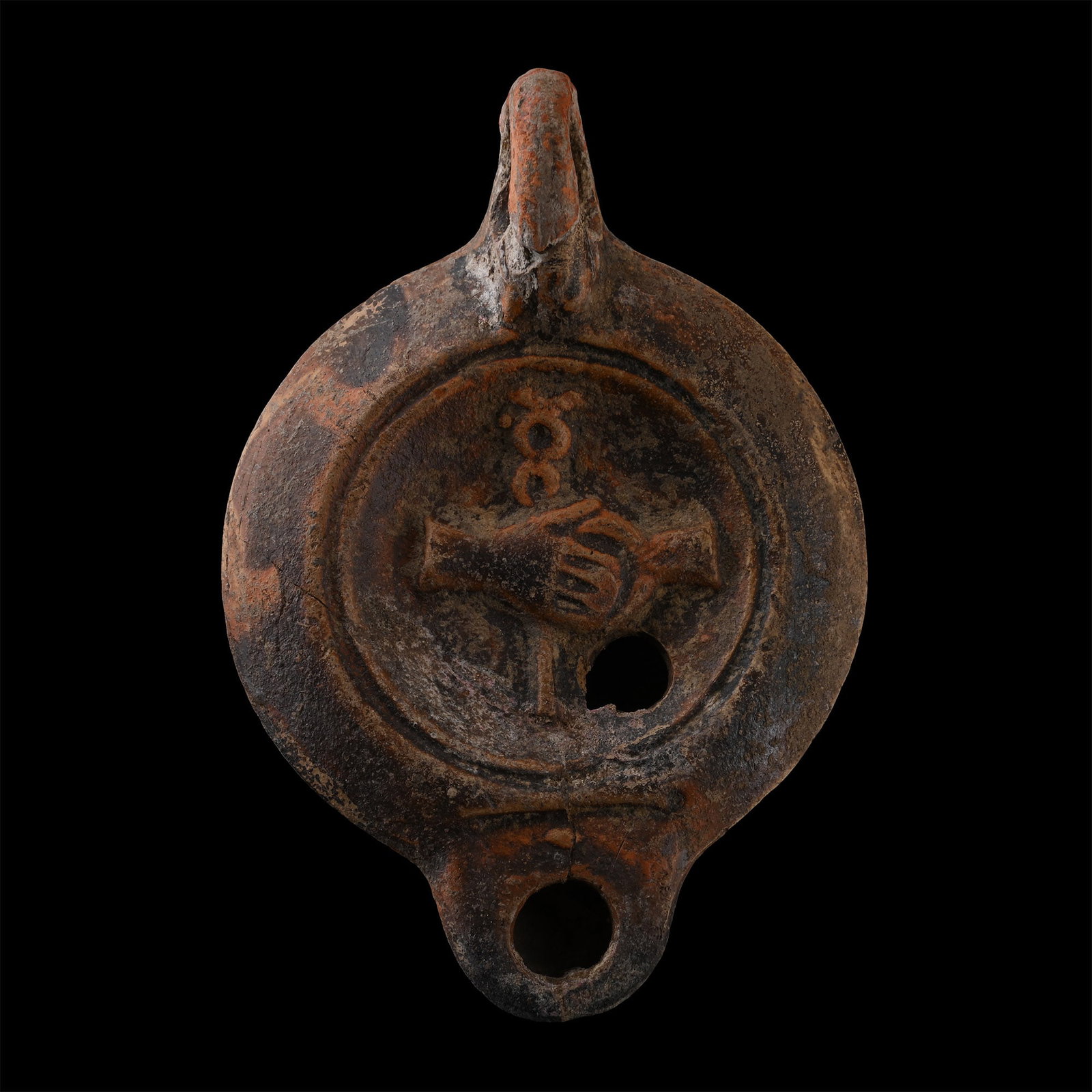 Roman Terracotta Oil Lamp with Clasped Hands Holding a Caduceus: Circa 2nd century A.D. Circular body with short nozzle and a loop handle, discus with clasped hands before a caduceus. 57.5 grams, 92 mm (3 5/8 in.). [No Reserve] From the private collection of Mr Bri
