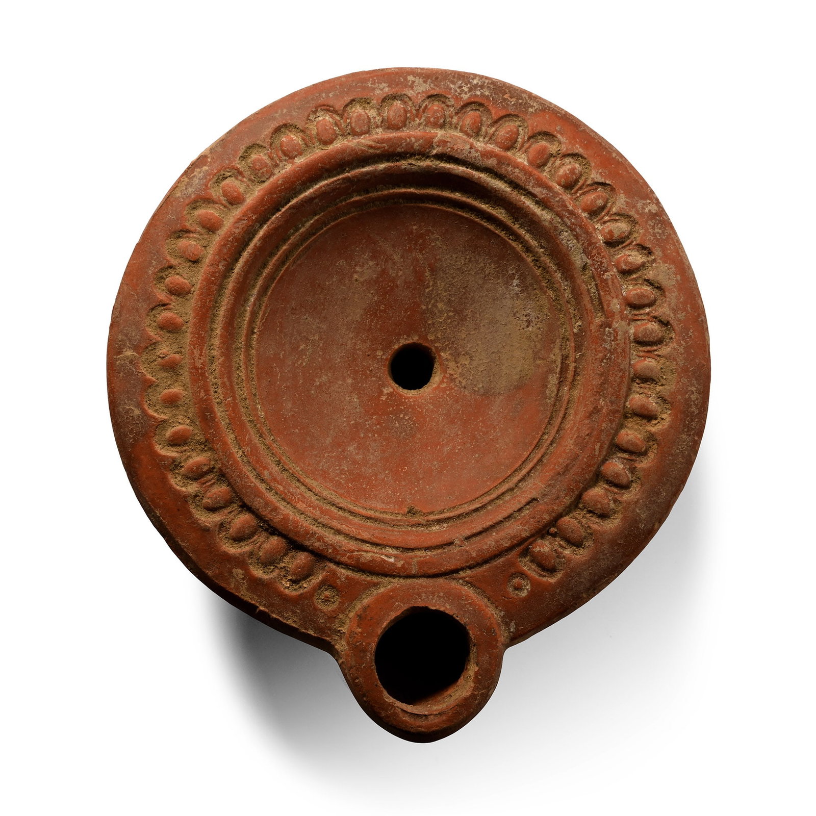 Roman Terracotta Oil Lamp: Cyprus, circa 2nd century A.D. Round body with plain discus with pelletted border, label on the base '2nd c. AD M10'. 45.1 grams, 86 mm (3 3/8 in.). [No Reserve] Private collection, Oxfordshire, UK, b