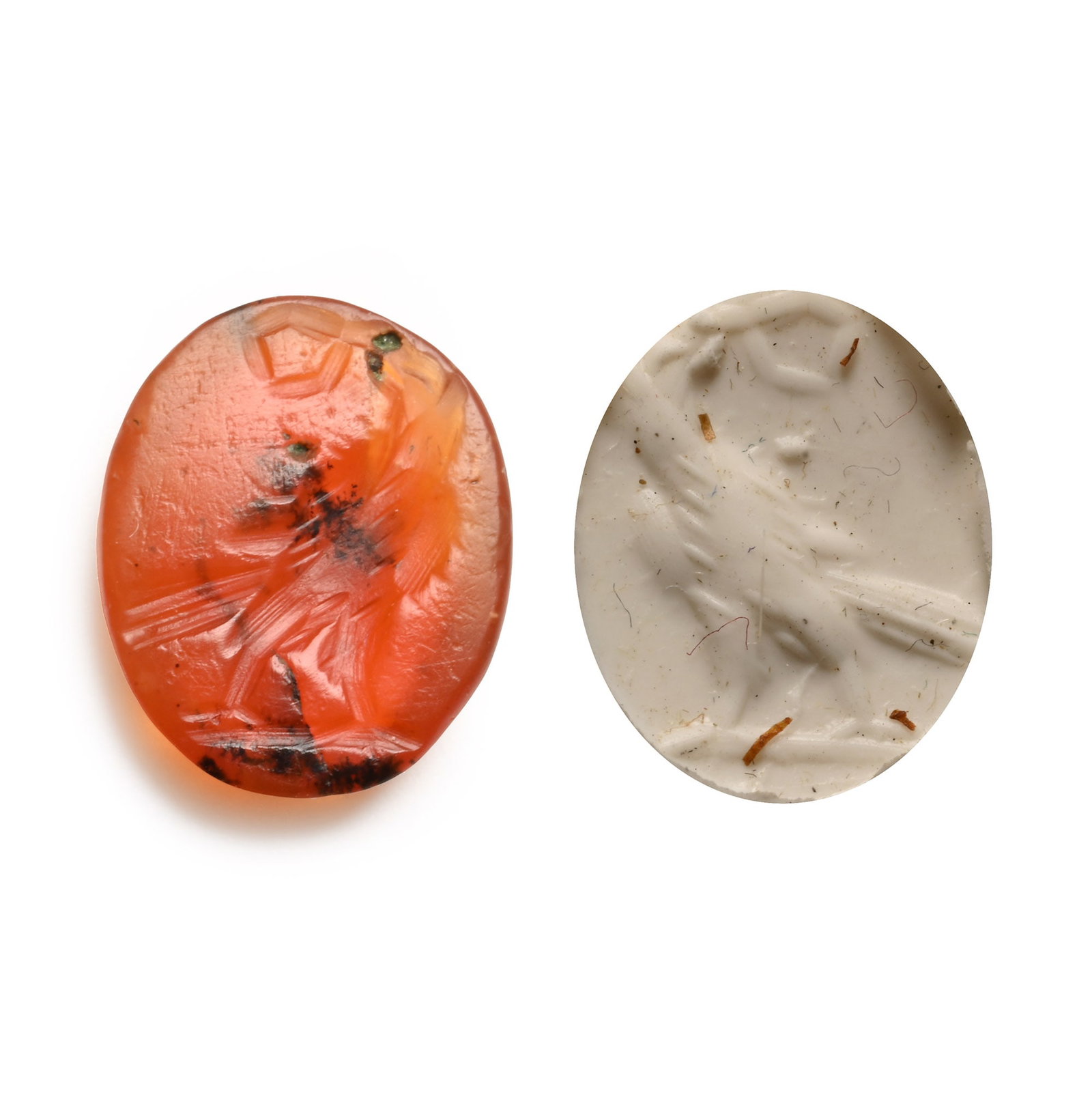 Roman Carnelian Gemstone with Eagle: 2nd-3rd century A.D. With intaglio eagle standing with head turned, wreath in the beak; supplied with a museum-quality impression. 0.44 grams, 11.61 mm (3/8 in.). [No Reserve] From the private collect