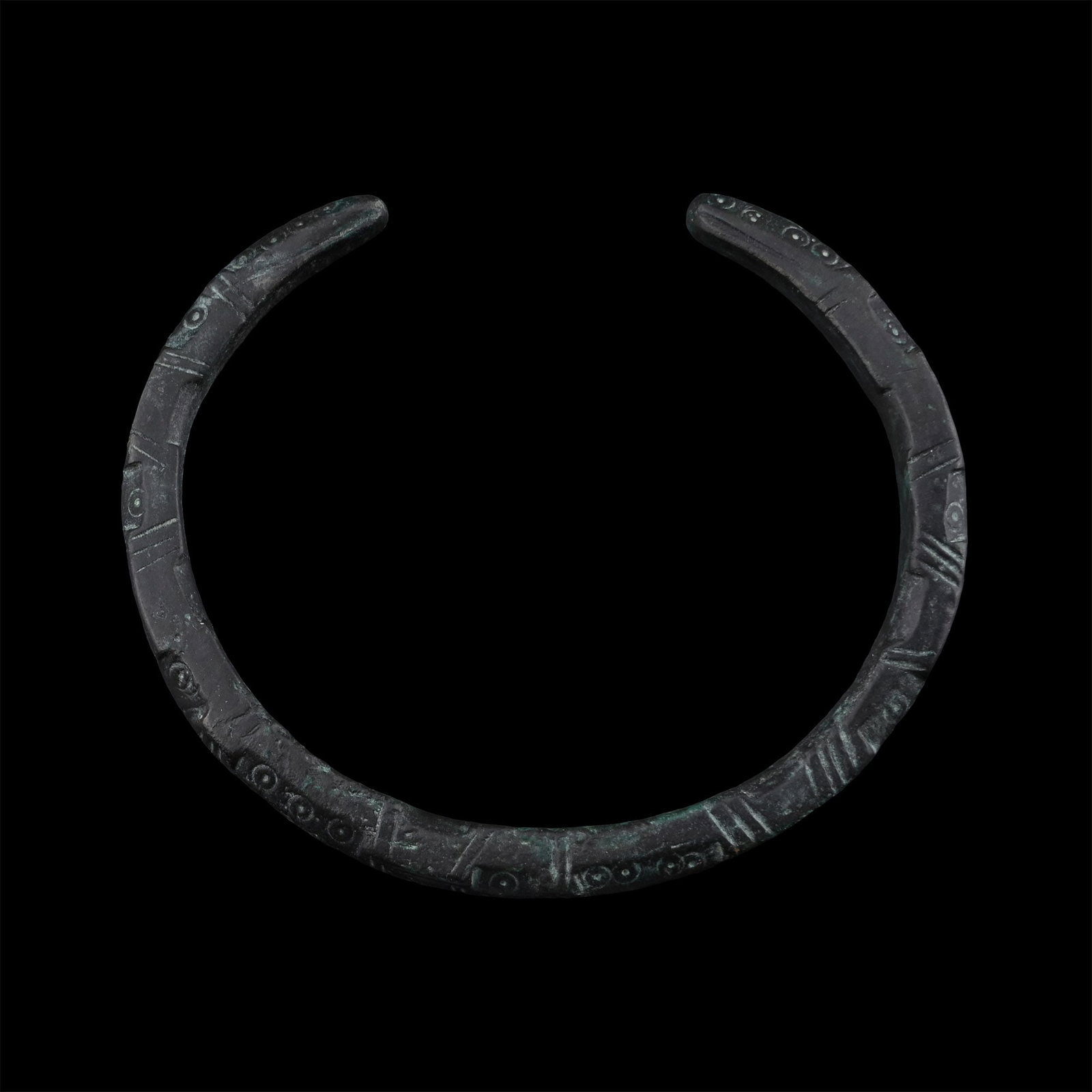 Roman Bronze Decorated Armilla Bracelet: 1st-4th century A.D. Penannular body divided into sections with linear and ring-and-dot decoration. 31.67 grams, 65 mm (2 1/2 in.). [No Reserve] Ex German art market, 2000s. Acquired from an EU collec