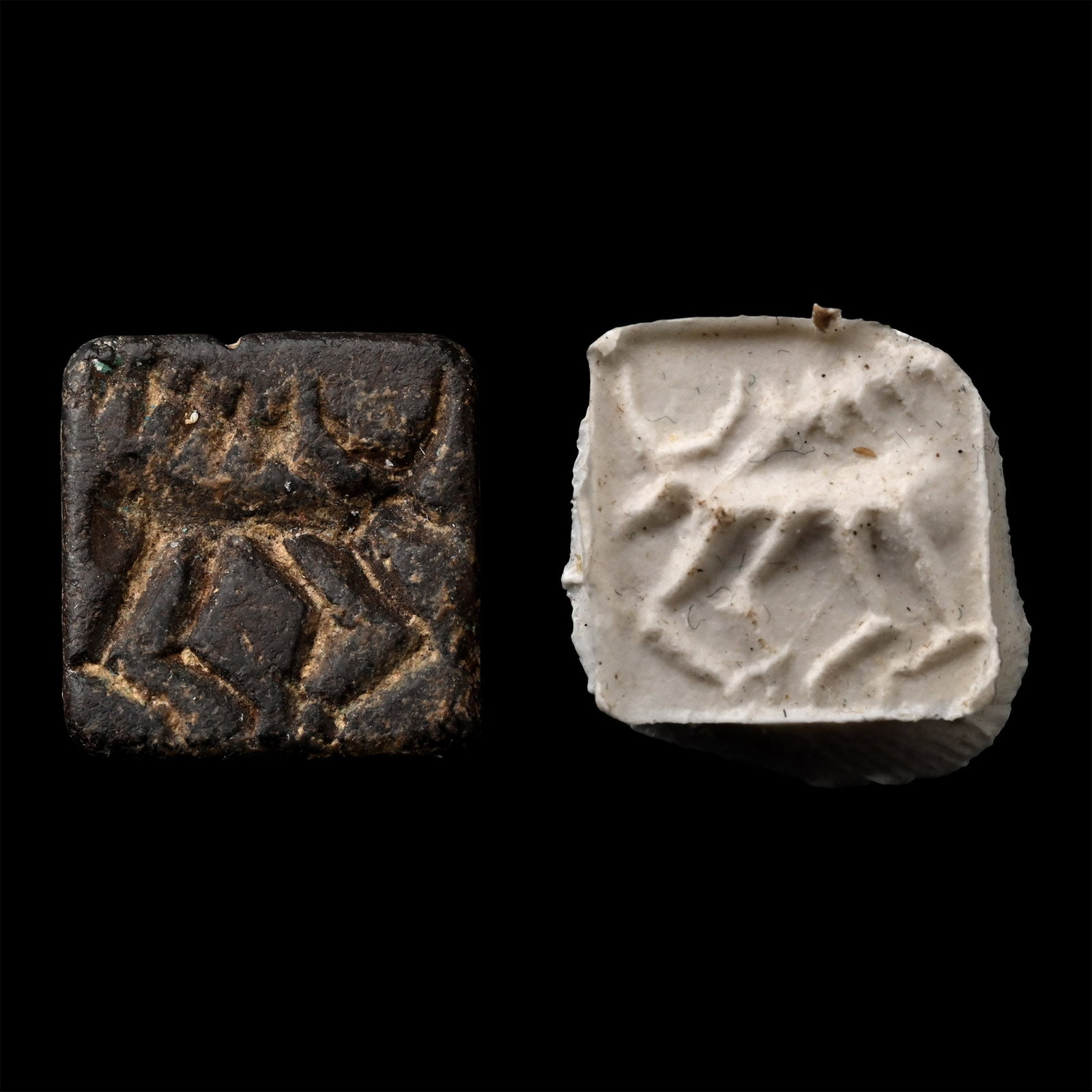 Western Asiatic Black Stone Stamp Seal with Animal: 2nd millennium B.C. Square in plan with chamfered sides and ribbed loop above; incuse motif of an advancing bull. 1.87 grams, 12.13 mm (1/2 in.). [No Reserve] From the private collection of a European