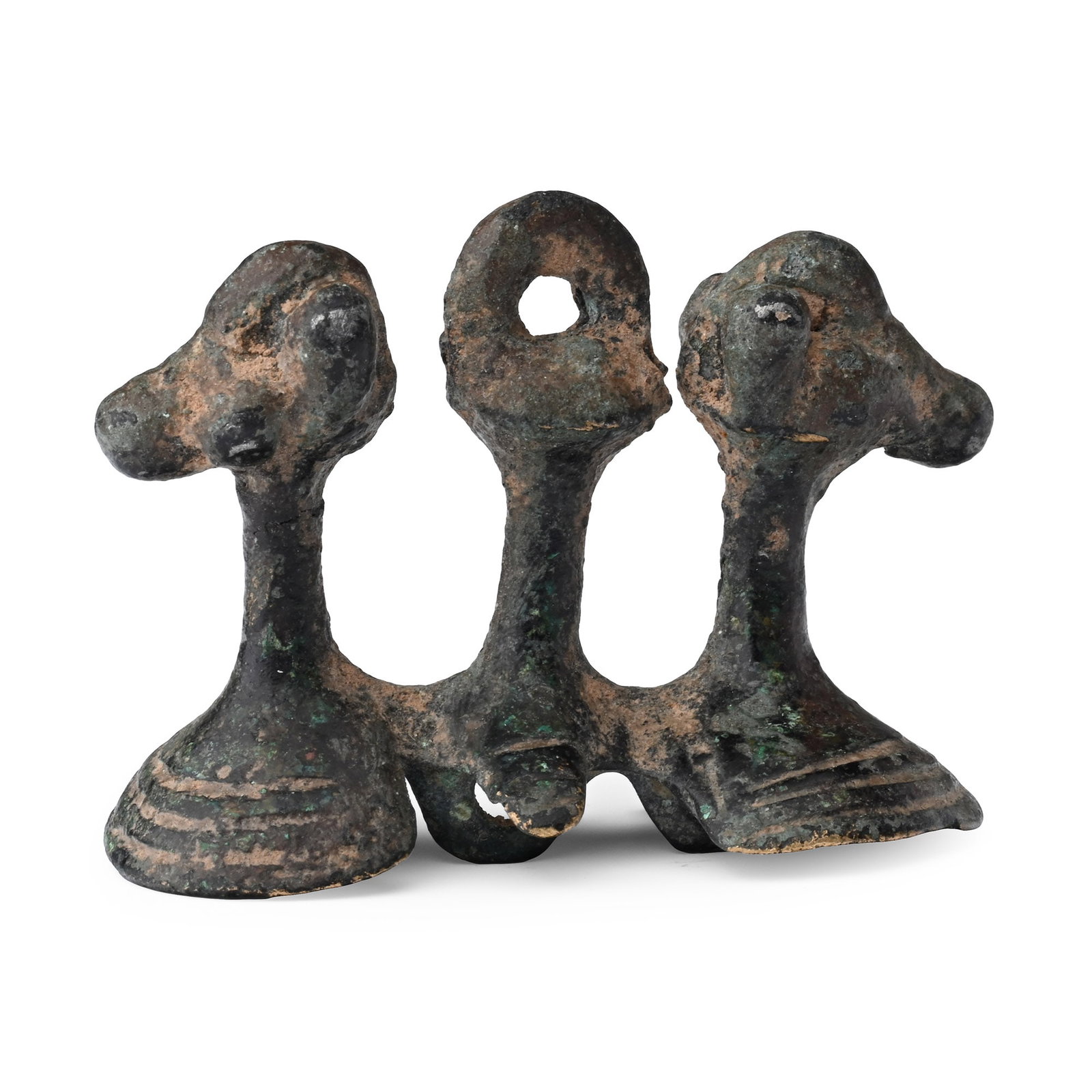 Western Asiatic Bronze Double Animal Mount: 1st millennium B.C. Comprising a short stem with pierced lug finial flanked by two addorsed beast-heads; mounted on a cupped base with attachment loops beneath. 22.47 grams, 44.29 mm (1 3/4 in.). [No 