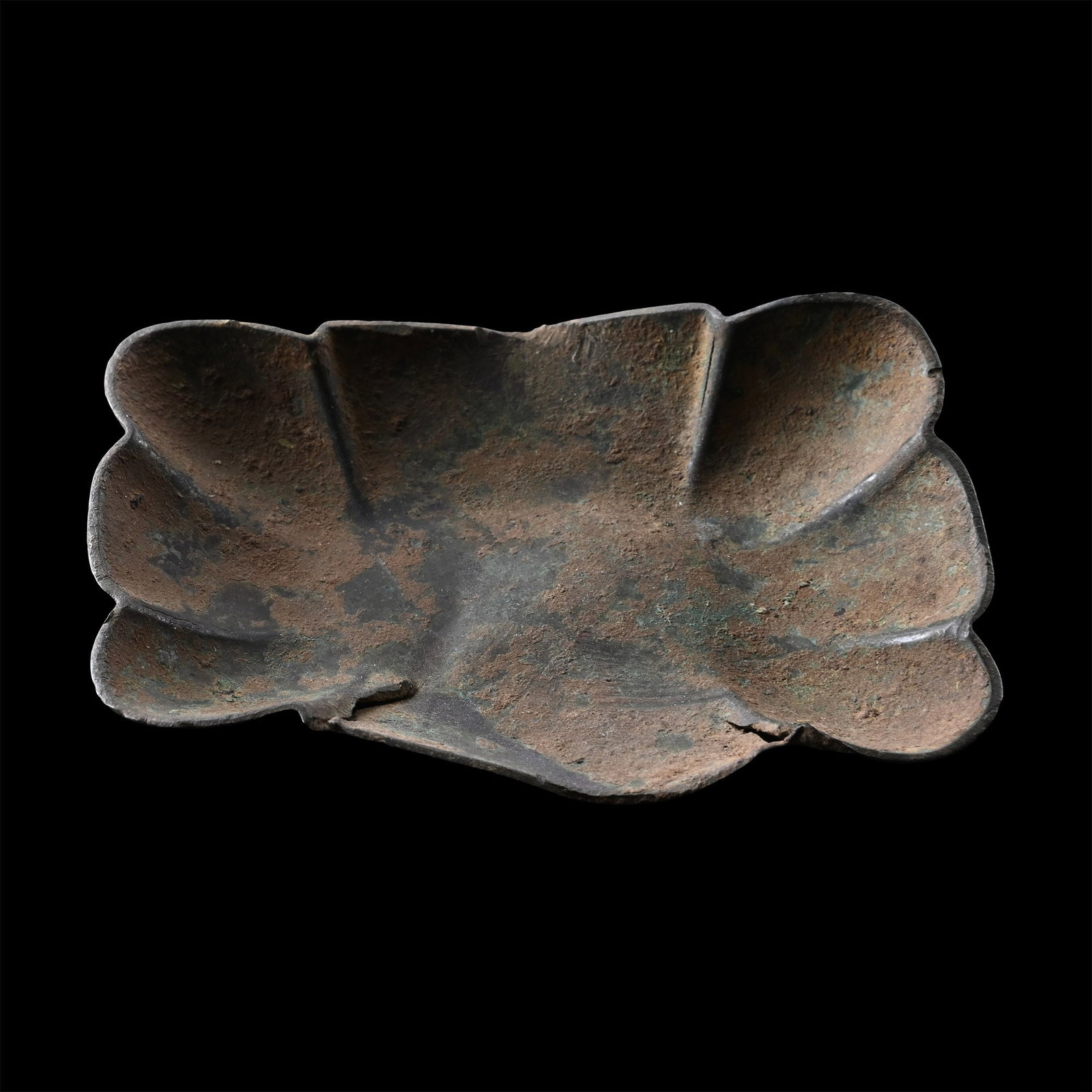 Sasanian Bronze Petalled Dish: 3rd-7th century A.D. Formed as a rectangle with each side formed into three lobes and slightly dished. 64 grams, 99.27 mm (3 7/8 in.). [No Reserve] From the private collection of a European gentleman 