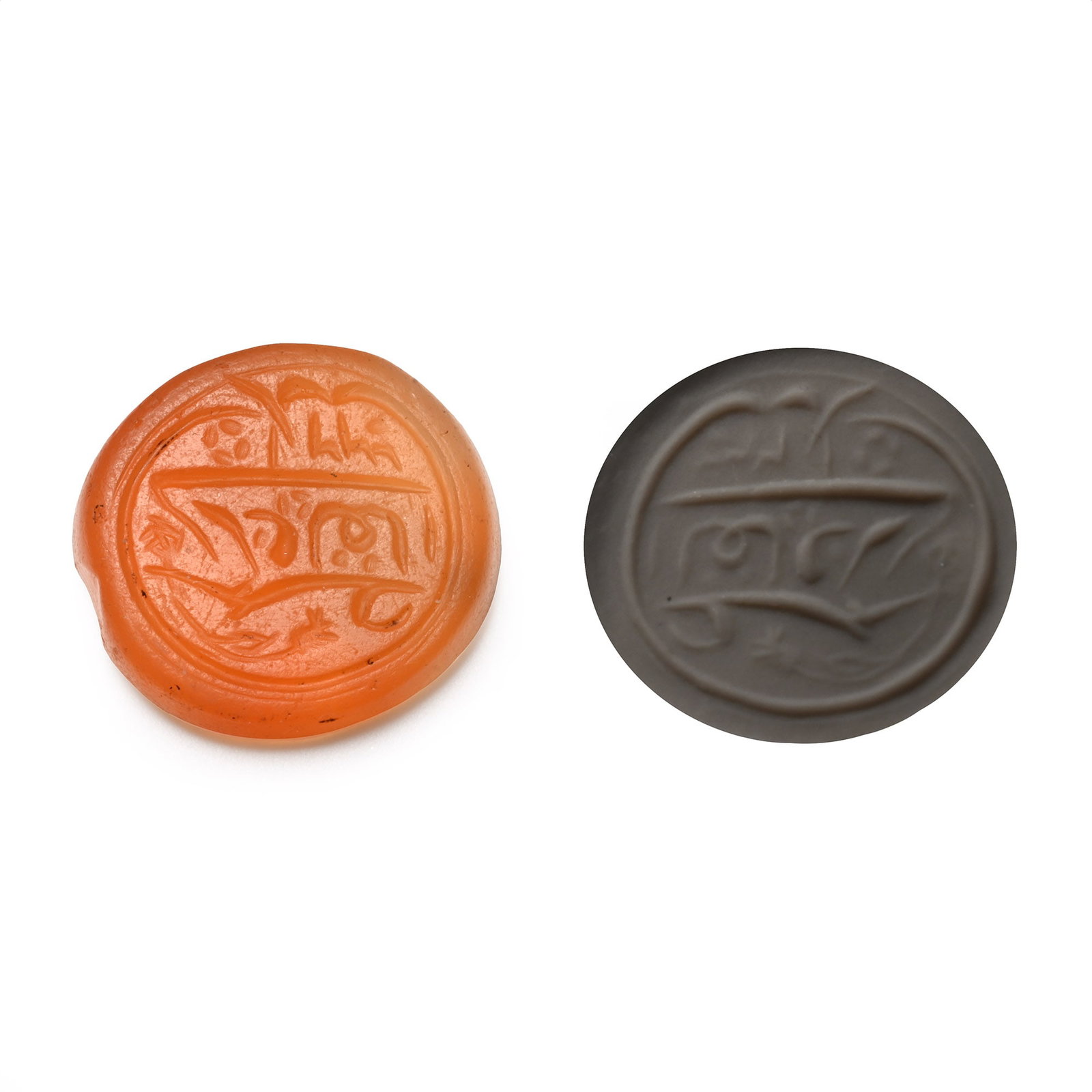 Western Asiatic Engraved Carnelian Calligraphic Intaglio: Late 19th-20th century A.D. An oval intaglio with a two-line inscription and floral motifs; supplied with a museum-quality impression. 1.85 grams, 16 mm (5/8 in.). [No Reserve] Acquired in the late 19