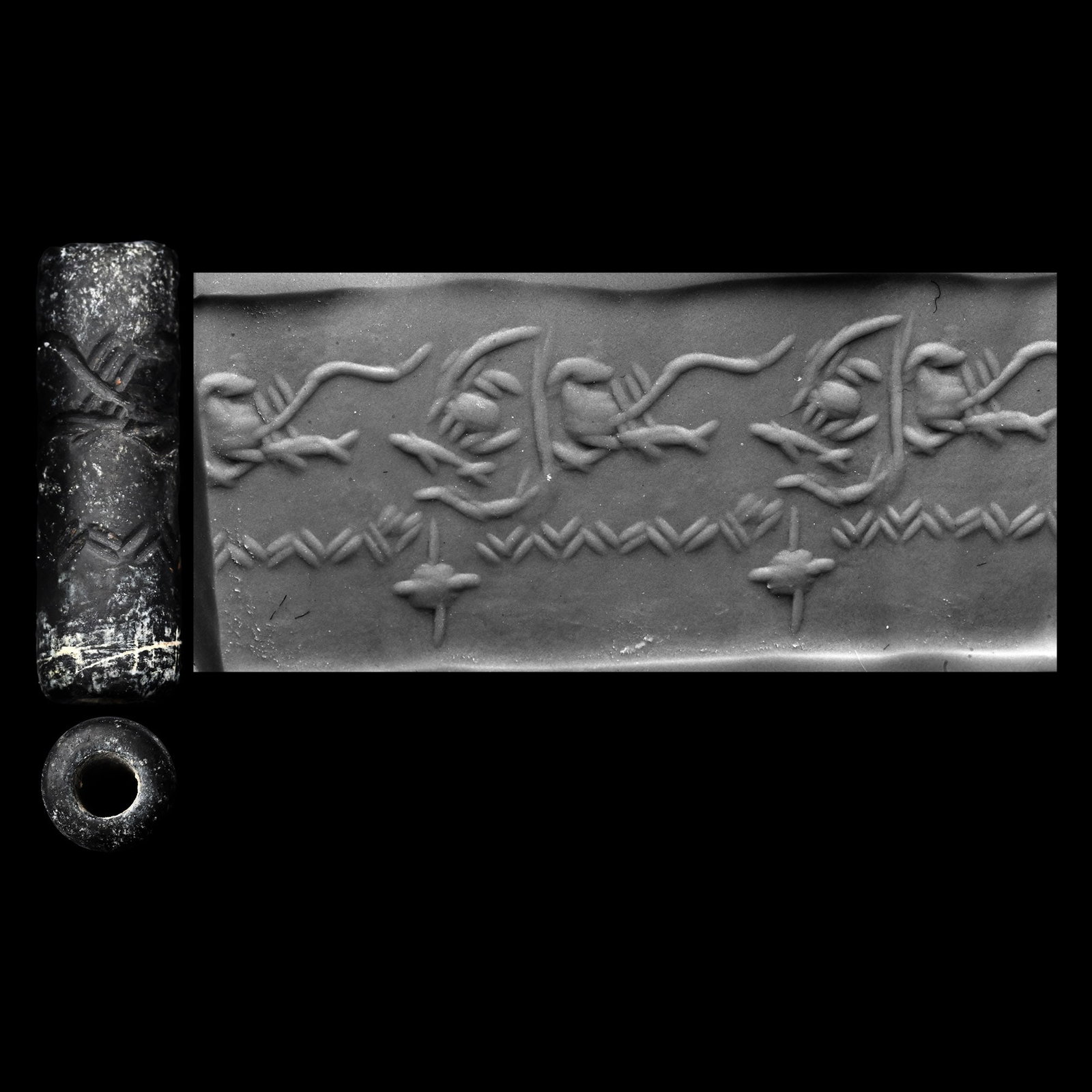 Western Asiatic Black Stone Cylinder Seal with Sea Creatures: 2nd-1st millennium B.C. Frieze with horizontal line of chevrons above an aquatic scene with fish and a crab, objects in the field; supplied with a museum-quality impression. 0.78 grams, 17.52 mm (5/8 