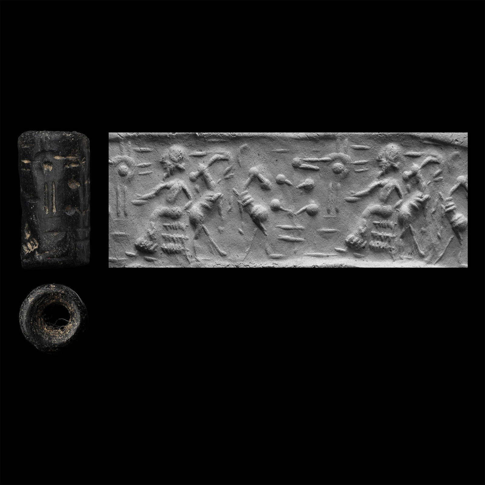 Western Asiatic Black Stone Cylinder Seal with Court Scene: 2nd-1st millennium B.C. Frieze depicting a court scene with a profile figure seated on a throne with ibexes fighting to the rear, tree and sunburst motif; supplied with a museum-quality impression. 2.