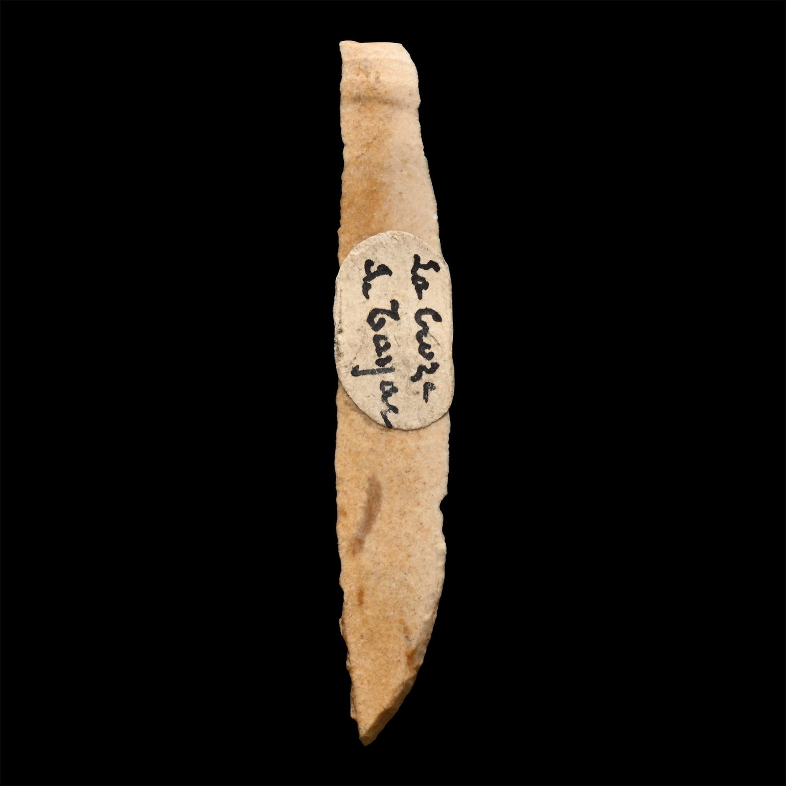 French Stone Age Knapped Flint Point: Gravettian Period, circa 33,000-21,000 B.P. Triangular in section with old collector's label 'La Groze du Tayac'. 1.00 grams, 46.69 mm (1 3/4 in.). [No Reserve] From Le Groze - Du Tay. Acquired in the