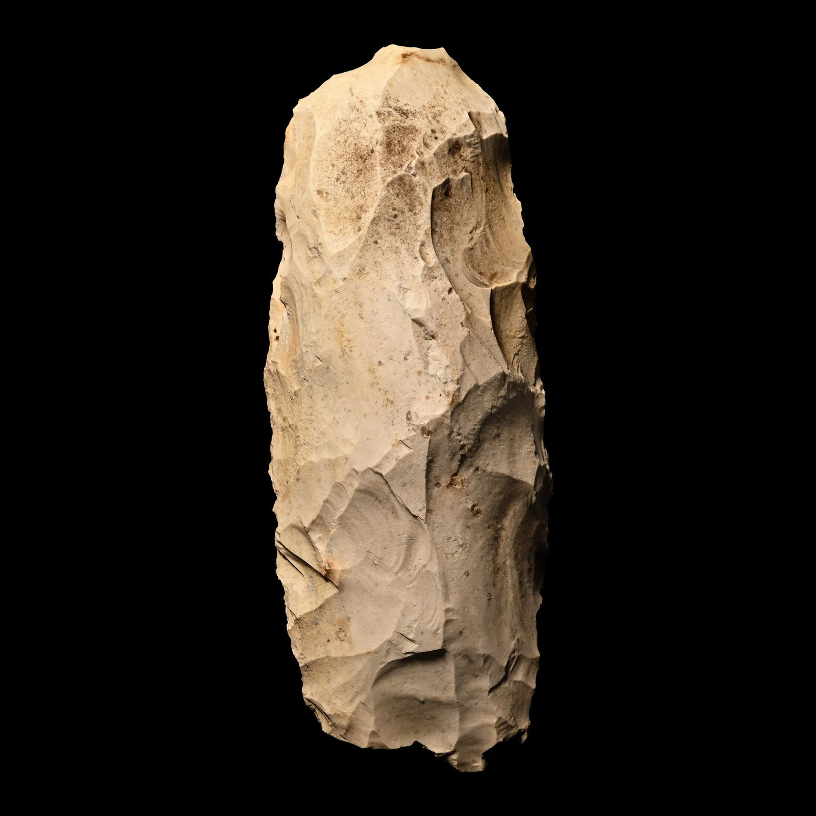 French Stone Age Knapped Cream Flint Adze: Mesolithic Period, circa 12,000-8,000 B.P. Tongue-shaped with rounded butt; tip broken. 234 grams, 13 cm (5 1/8 in.). [No Reserve] Acquired in the 1970s-1990s. From the collection of the famous UK mus