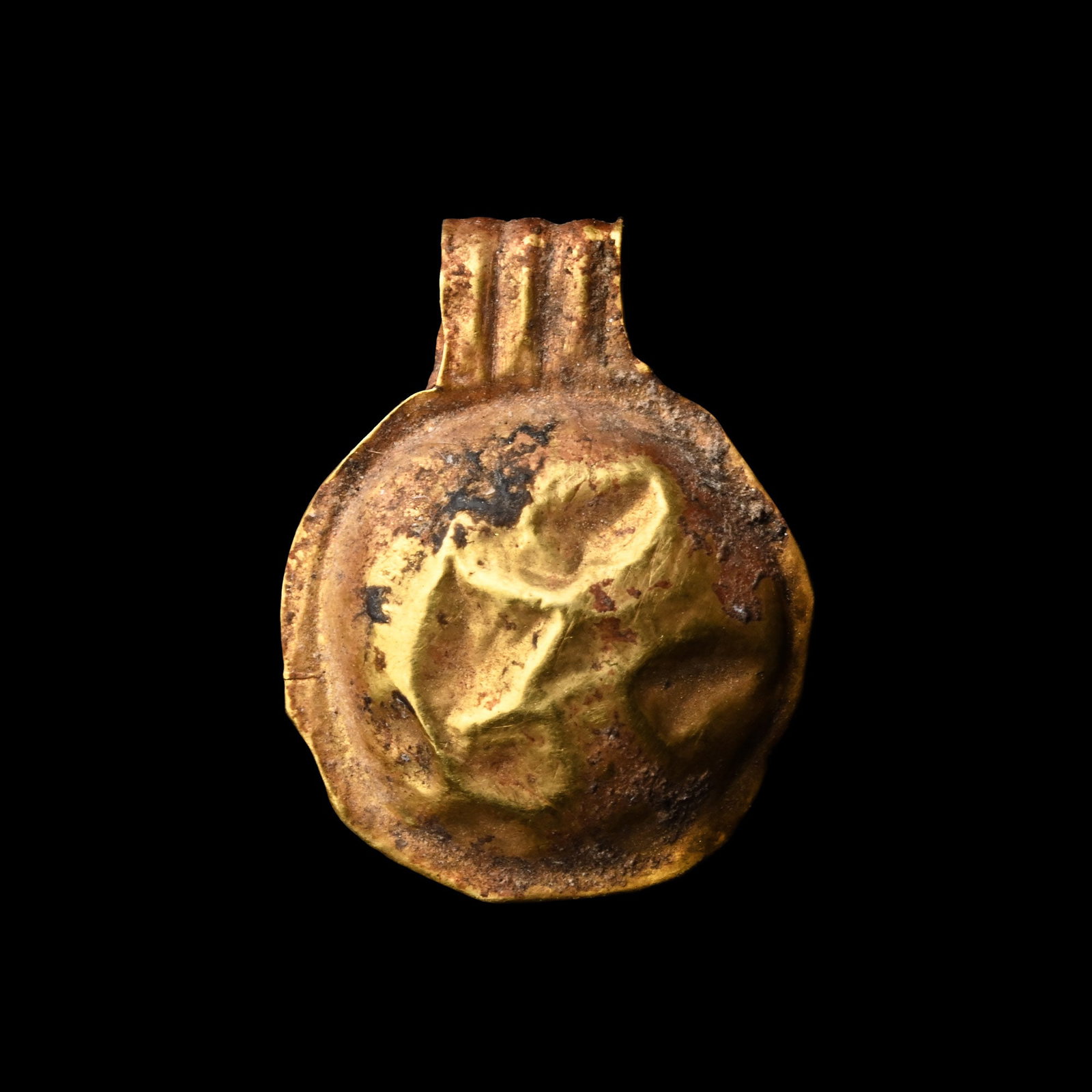 Saxon Gold Bulla-Shaped Pendant: Circa 6th century A.D. A hollow-form pendant with a ribbed suspension loop. 0.41 grams, 15.5 mm (5/8 in.). [No Reserve] From the private collection of a European gentleman (1942-2024), formed since th