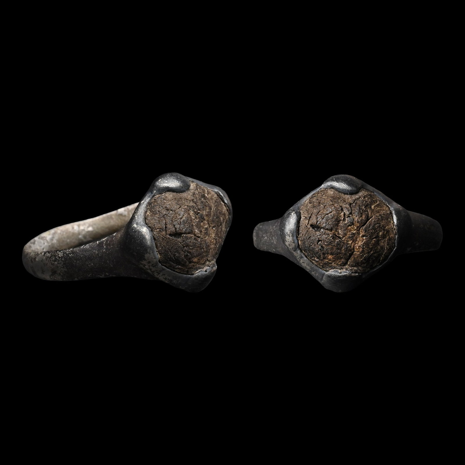 Viking Age Silver Ring with Cabochon: Circa 900-1100 A.D. Comprising a slender hoop with a circular bezel set with an amber(?) cabochon. 3.34 grams, 23.43 mm overall, 18.03 mm internal diameter (approximate size British O, USA 7, Europe 1