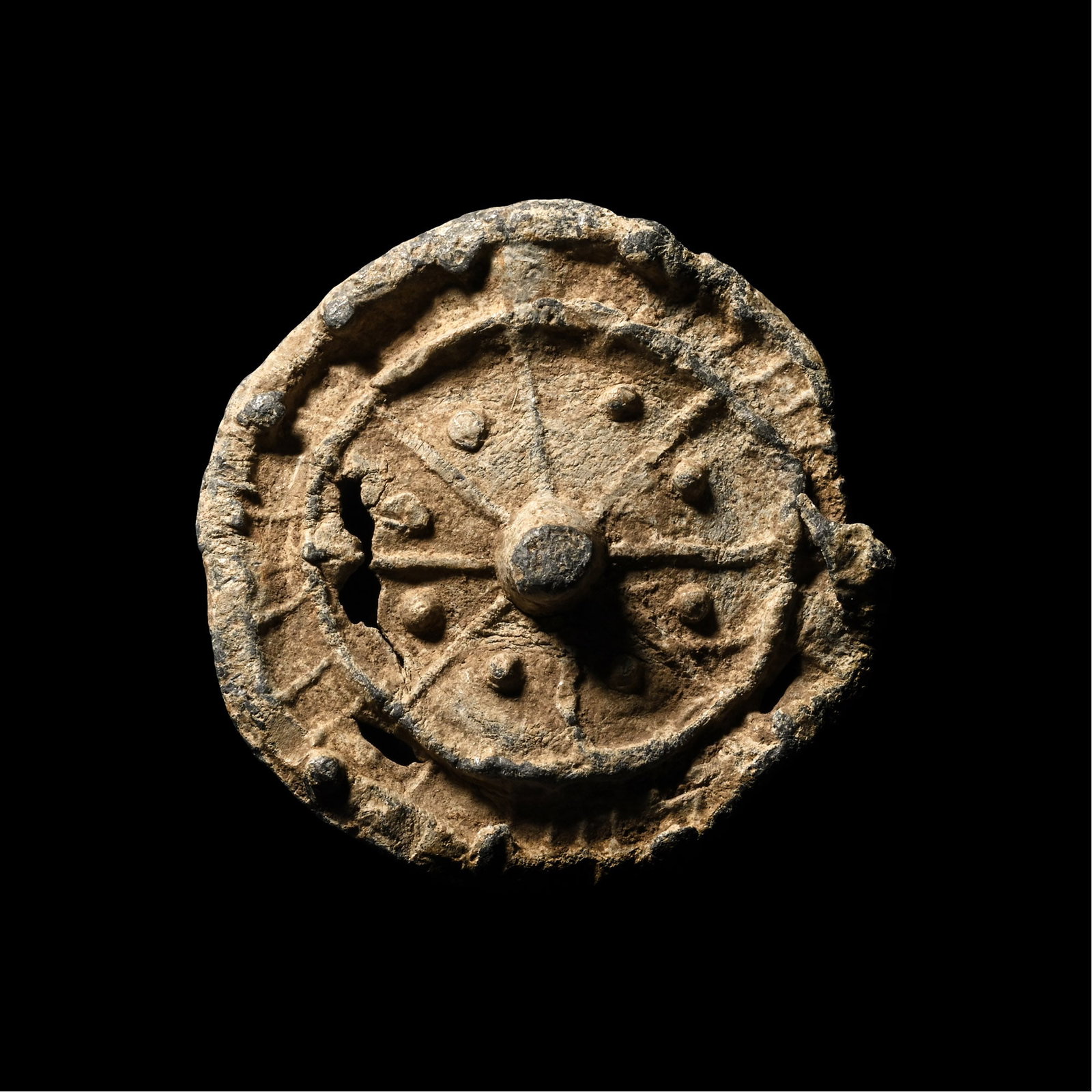 Medieval Pewter Circular Pilgrim's Badge: Circa 14th-15th century A.D. Discoid in plan with raised rim and inner ring with spokes, central boss and radiating arms and interstitial pellets. 12.42 grams, 32 mm (1 1/4 in.). [No Reserve] From a r