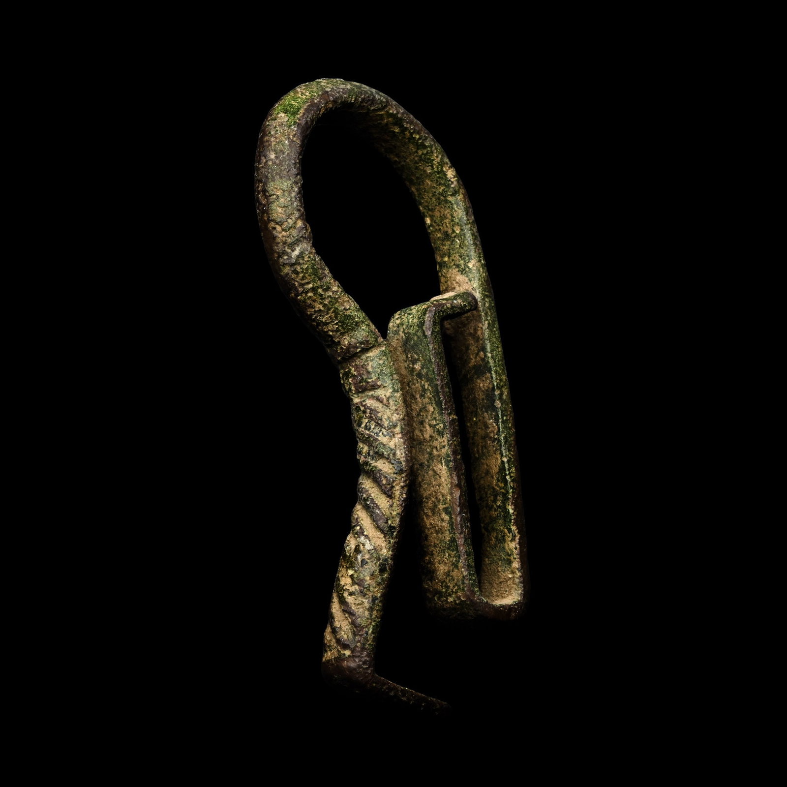 Medieval Bronze Sword Hanger: Lincolnshire, 14th-16th century A.D. Comprising a rectangular slot and a thick penannular bar with carination, a vertical bar with a flattened finial. 21 grams, 63 mm (2 1/2 in.). [No Reserve] Found i