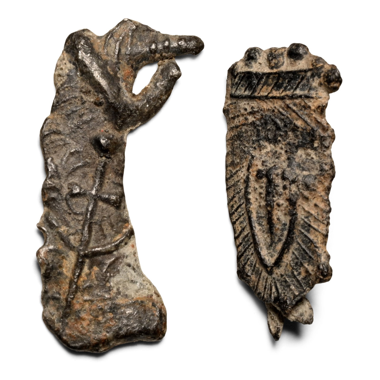 Medieval Pewter Thomas Beckett Sword Pilgrim's Badge Group: Circa 14th-15th century A.D. Comprising: one openwork fragment with a low-relief sword; one tongue-shaped with a hatched border, vesica panel with a sword to the centre, pin to the reverse. Cf. Mitchi