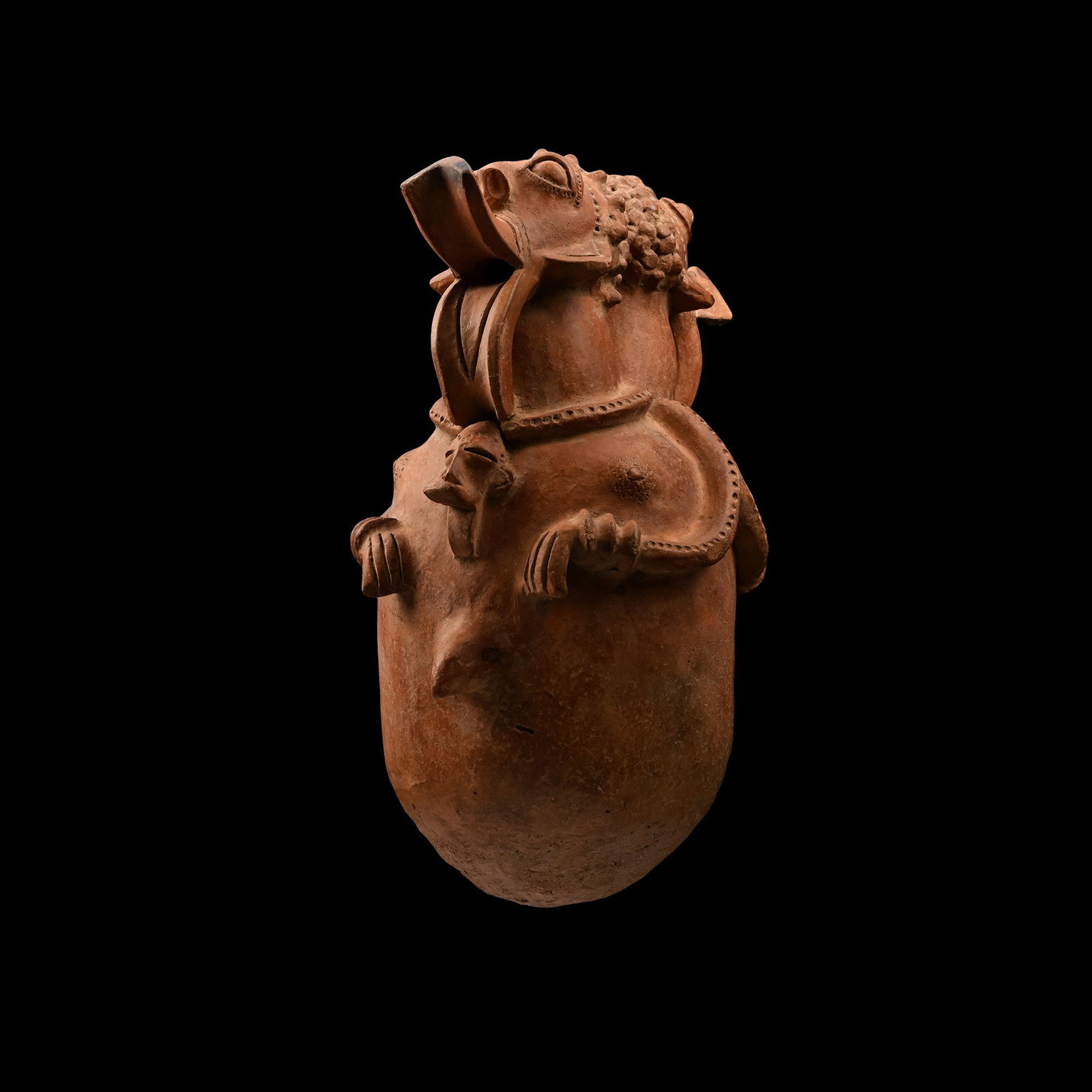 Large African Style Terracotta Vessel: 20th century A.D. Comprising a barrel-shaped body with a rounded underside, addorsed human heads each on a long, curved neck, with applied pellets for the hair, a scooped beak for the mouth, applied b