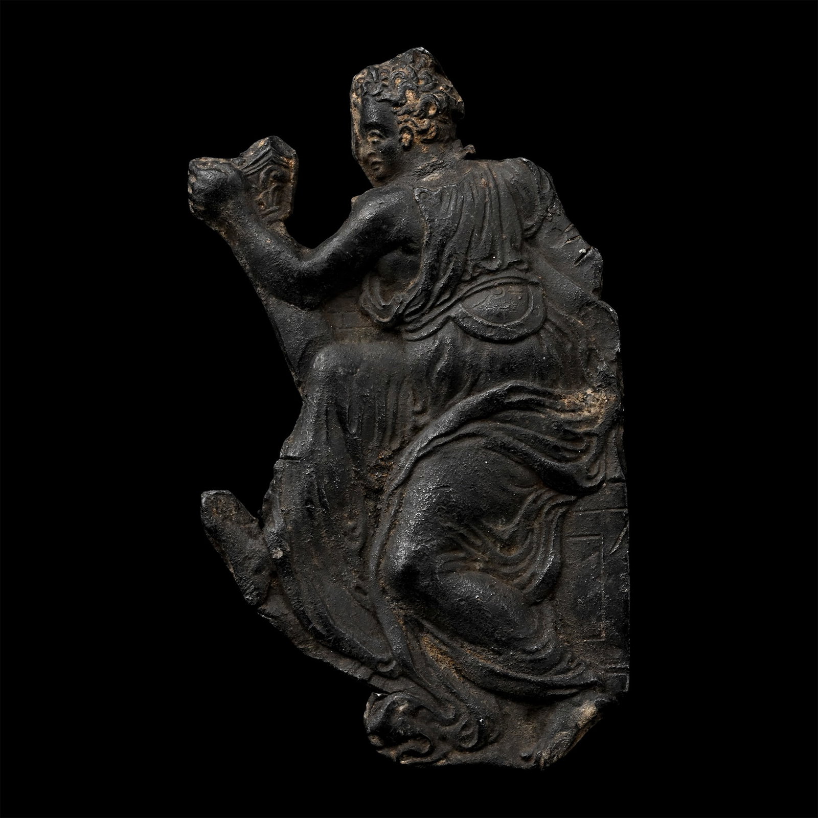 Renaissance Lead Fragment of a Draped Female: 16th century A.D. Appliqué fragment with a figure in a loosely draped palla turning to hold a cup in one hand. 11.04 grams, 55 mm (2 1/4 in.). [No Reserve] From the private collection of a European g