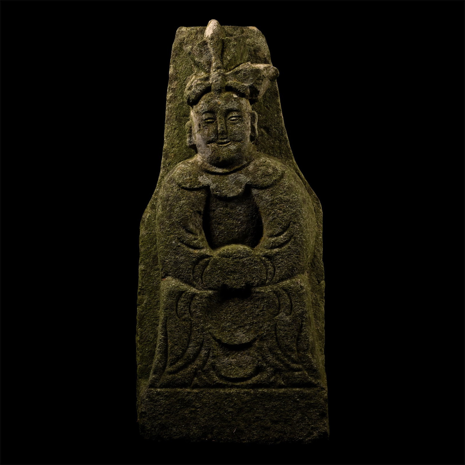 Chinese Stone Figure of a Dignitary, Member of the Wu Family: Daoguang Era, 1823 A.D. On a square-section base, modelled in the half-round figure seated on a throne with rosette and other ornament, wearing an ankle-length robe and a tall headdress; triangular pa