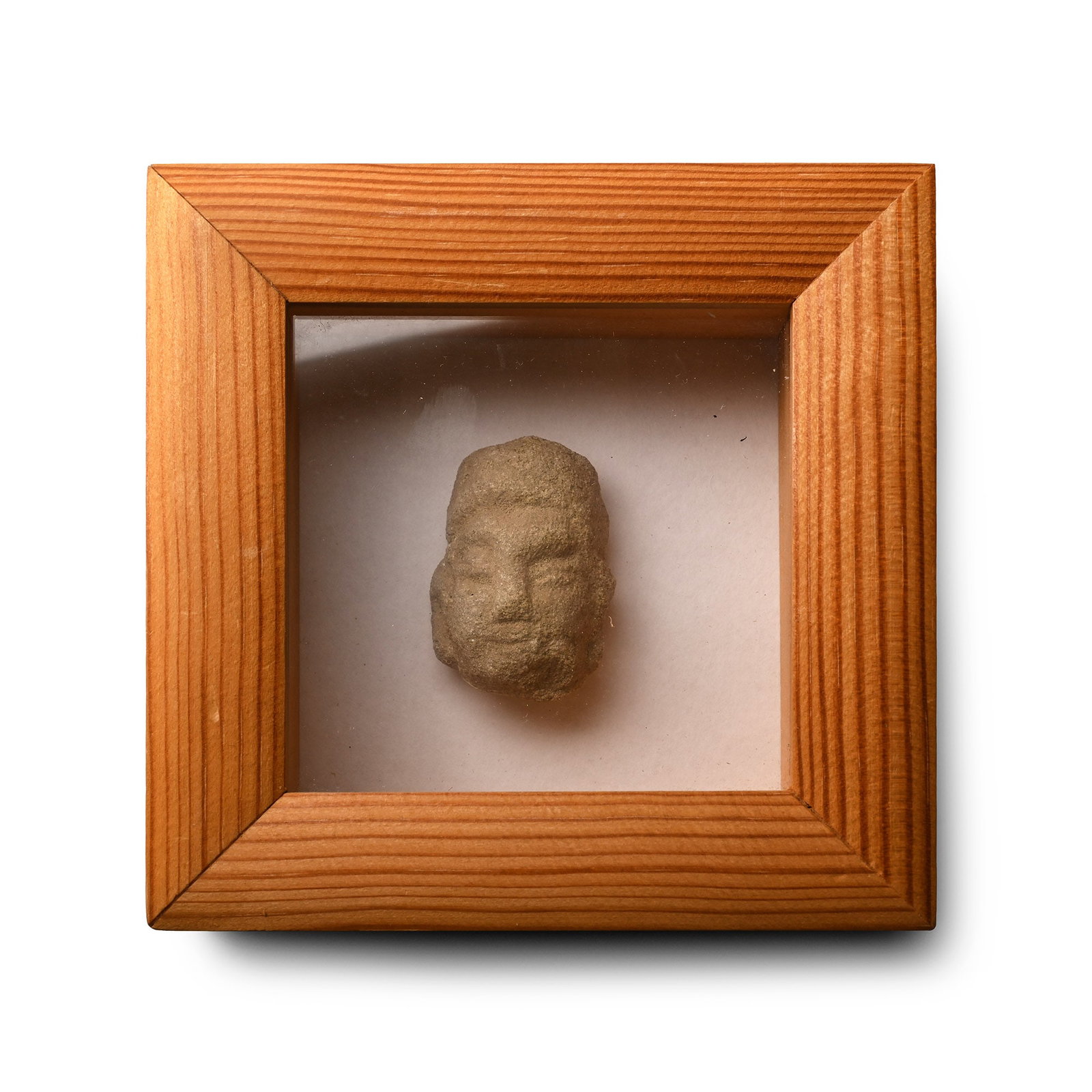 Framed Chinese Song Terracotta Head: Song Period, 10th-11th century A.D. The head modelled in the half-round with rounded cheeks and large ears; set in a glazed wooden display frame. 252 grams total, 11.8 x 11.9 cm including frame (4 5/8