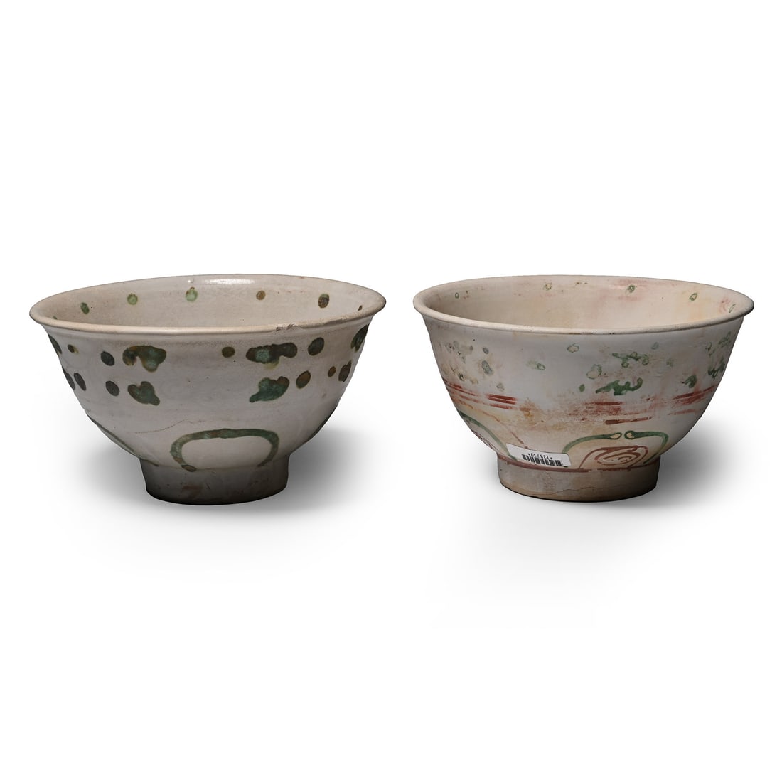 Hoi An Cargo Shipwreck Glazed Bowl Pair: 15th century A.D. Comprising two deep bowls with everted rims, one with polychrome floral motifs and the other with green petals and pellets. 587 grams total, 13.3-13.7 cm (5 1/4 - 5 3/8 in.). [2, No 