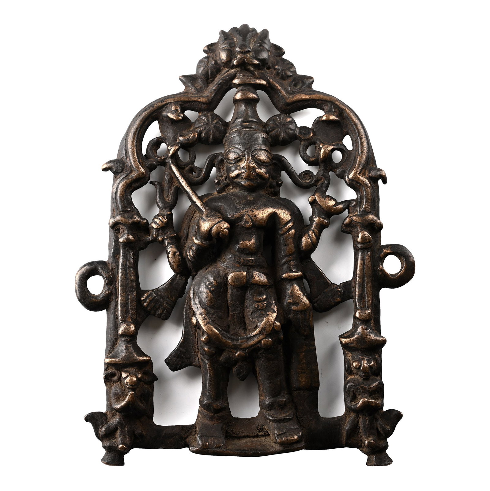 Sacred Copper-Alloy Plaque with Shiva and Attendants: India, 19th century A.D. Tongue-shaped plaque with a half-round figure of Virabhadra Shiva holding various attributes in an openwork arch. 945 grams, 21.5 cm (8 1/2 in.). [No Reserve] From an importan