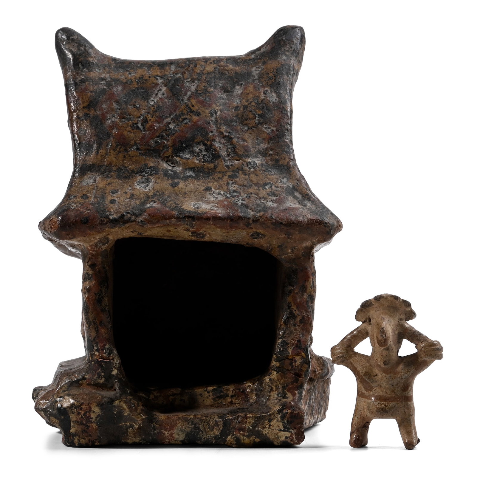 Nayarit Culture Terracotta Model of a House: Circa 200 B.C.-300 A.D. Rectangular in plan with flange rim to the thick base, one side open, gabled roof with broad eaves and tall finials; pigment detailing. See Holsbeke, M., Offerings for a New Li
