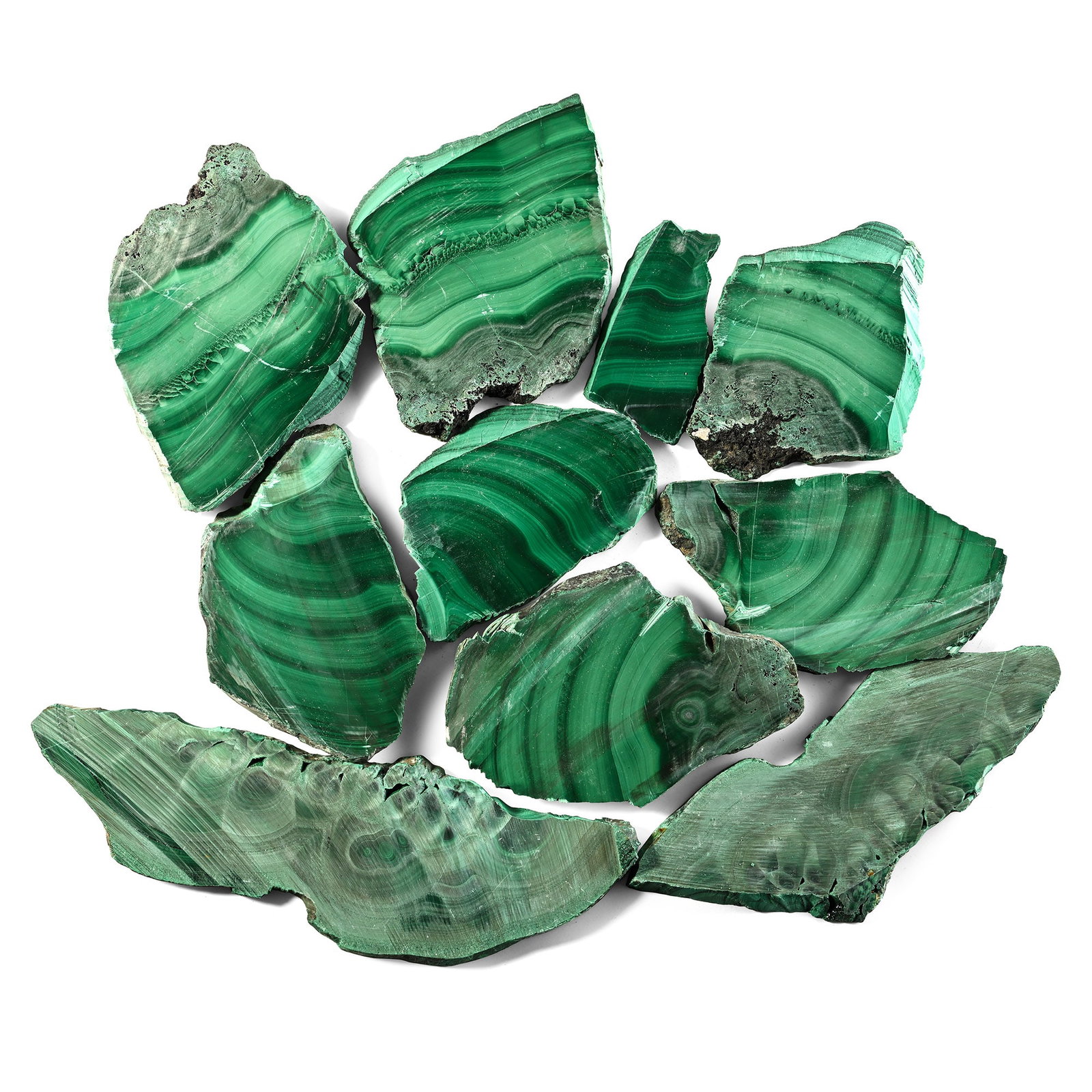 Group of Ten [10] Cut Malachite Slabs: Comprising ten irregular sections showing contrasting light and dark banding on both sides. 1.21 kg total, 7-18.5 cm (2 3/4 - 7 1/4 in.). [10,No Reserve] Ex Mineral Imports, London, UK. Gregory, Bottl