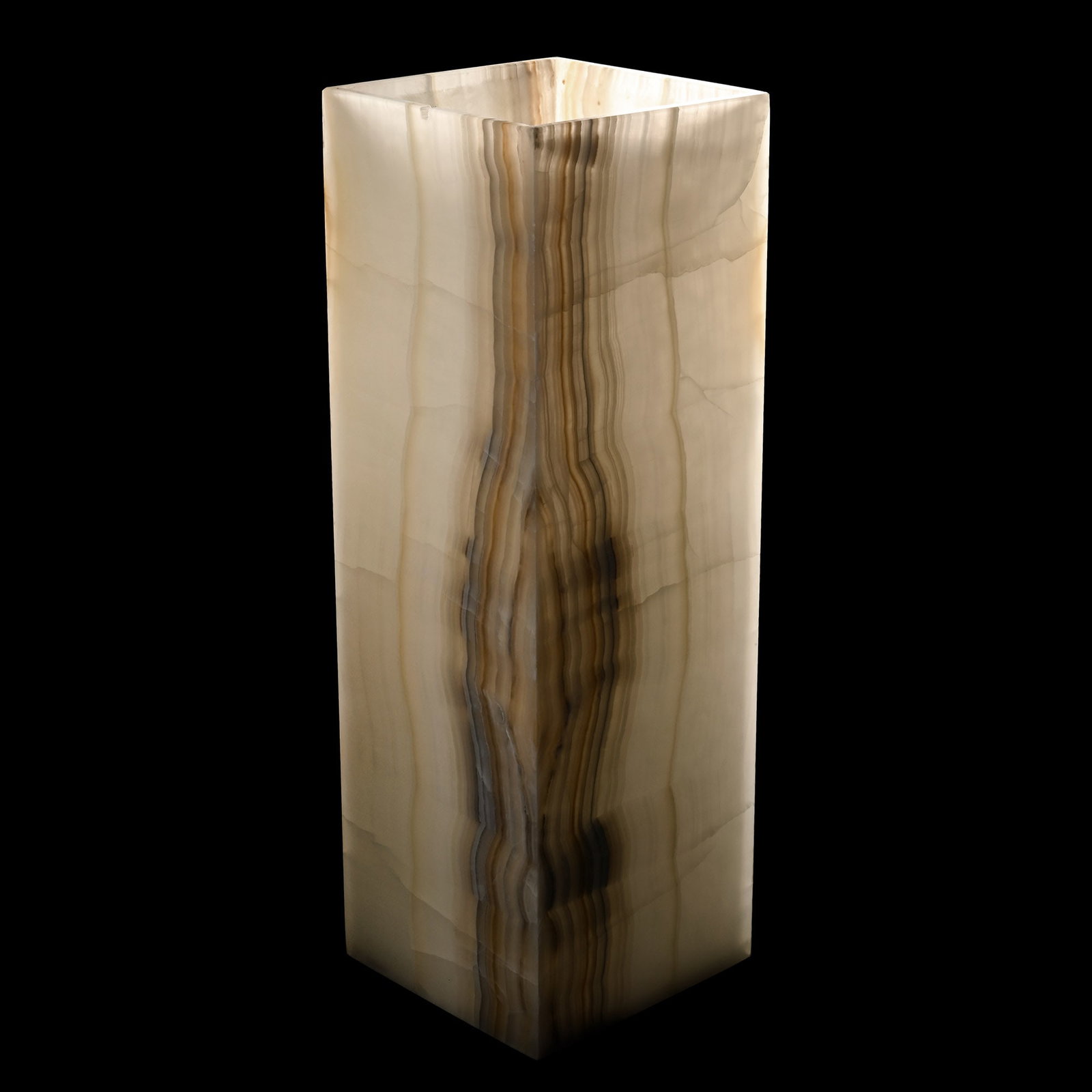Large Ivory Onyx Lamp: Comprising a tall, rectangular body formed of translucent cut slabs of milky stone with contrasting banding; accompanied by a separate light fitting on a stone base with US plug (not tested). 12.8 kg 