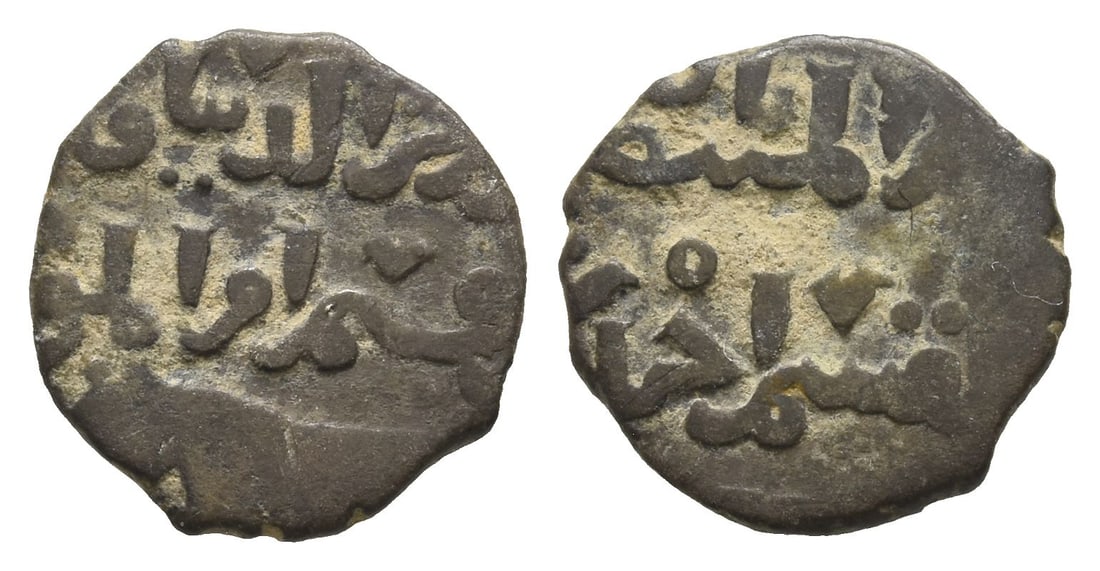 Mongols. Iklhans AE Fals.: 14th century AD. Inscription in two lines above lion walking to left / Inscription in two lines. 1.26gr, 13mm, 3h. From the collection of a gentleman, acquired on the London art market in the 1990s. T