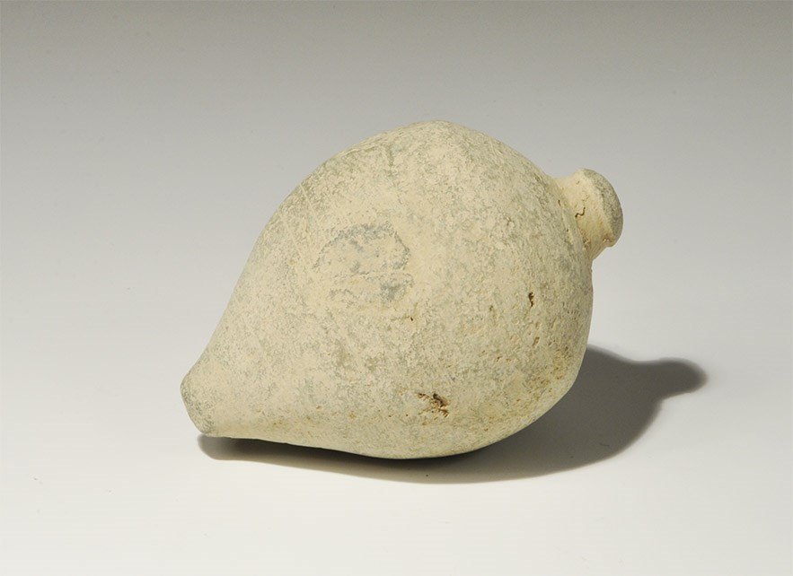 Byzantine Ceramic 'Greek Fire' Hand Grenade: Circa 10th century AD. A hollow ceramic vessel, piriform in profile, intended to be filled with incendiary liquid and a wick, and used as a hand grenade; thick circular rim enclosing the narrow mouth.