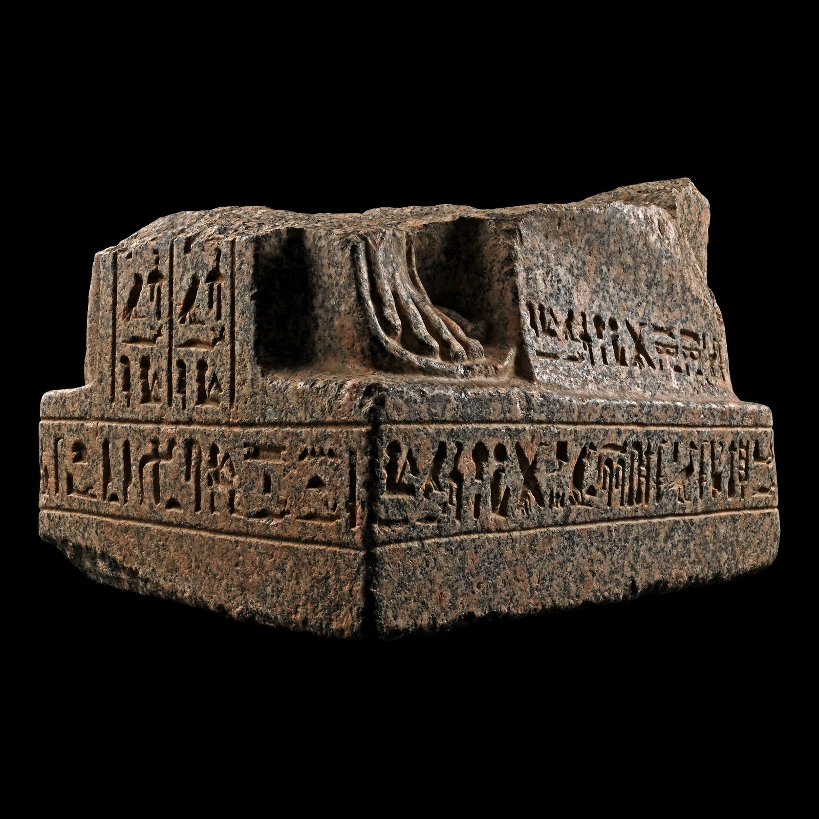 Monumental Egyptian Granite Statue Base For Prince Parahirwenemef: New Kingdom, 19th Dynasty, circa 1250 B.C. The reddish granite base and lower part of a kneeling statue of Prince Parahirwenemef, preserving the feet and lower legs with finely detailed sandals and we