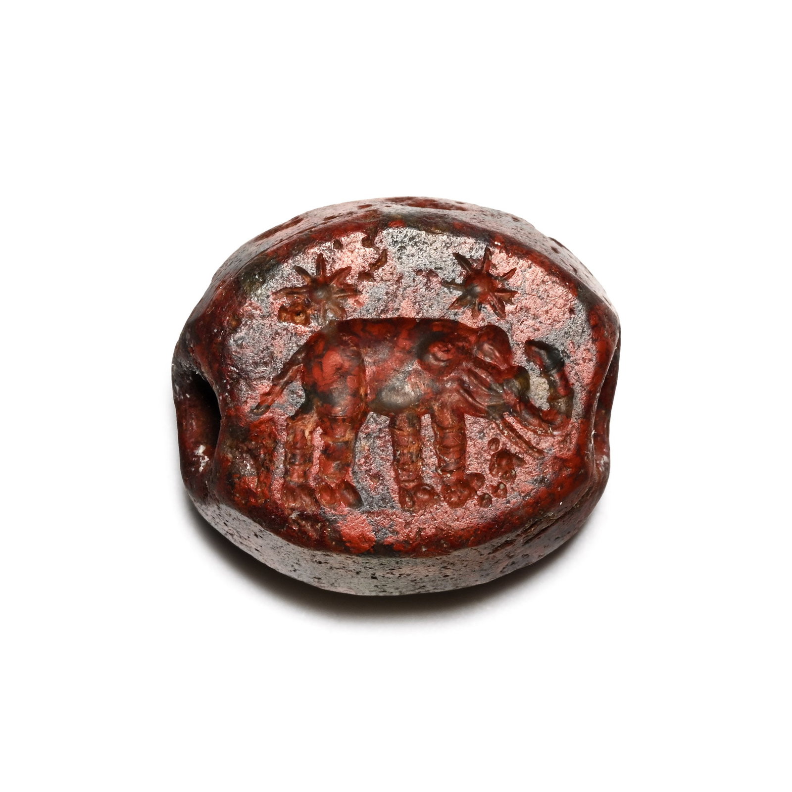 Roman Red Variegated Gemstone with Elephant: 3rd century A.D. Scaraboid type with incuse design to the underside of an elephant with stars above; supplied with a museum-quality impression. Cf. coin of Caesar showing a similar elephant in Go?y?ni