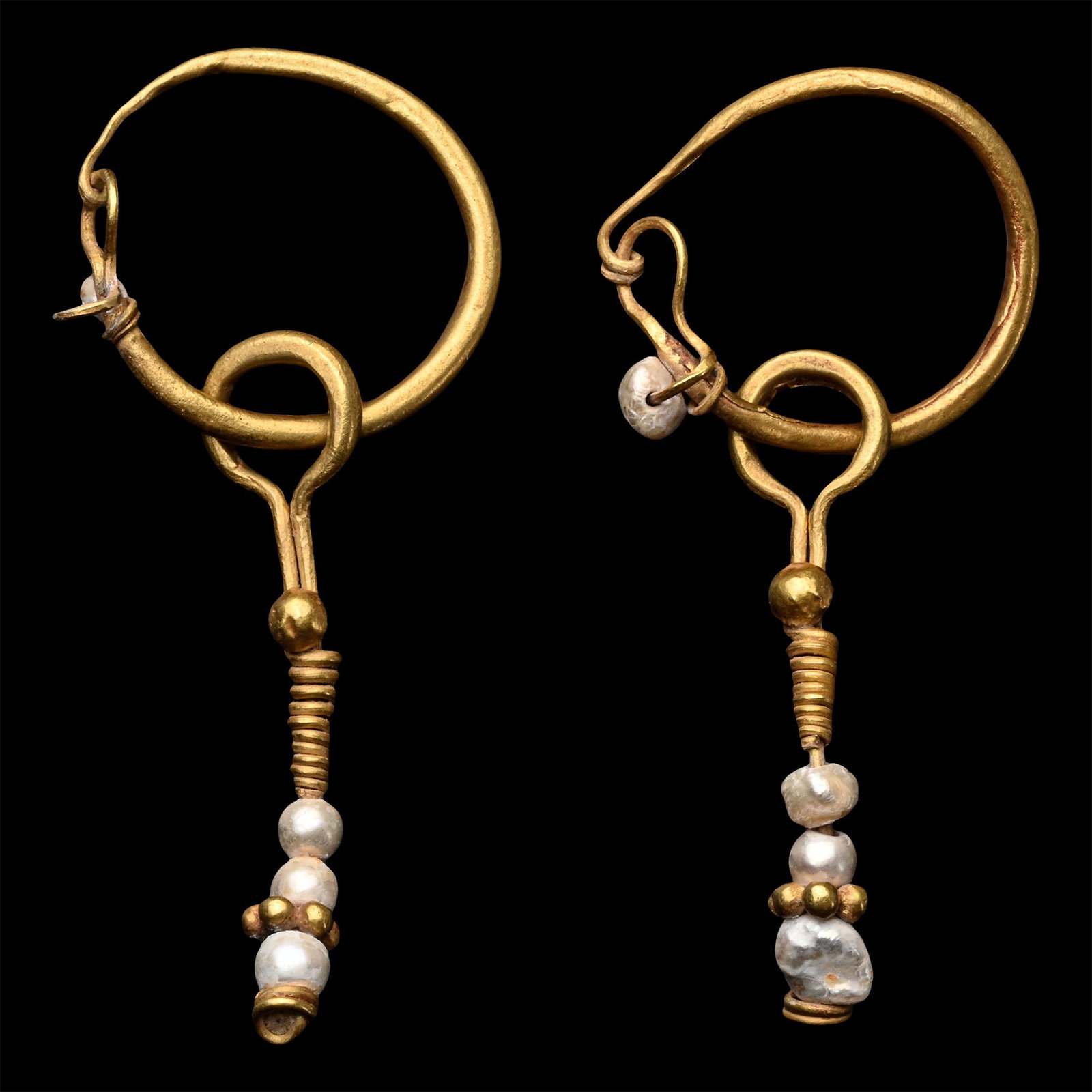 Roman Gold Earrings with Pearls: 2nd-3rd century A.D. Matched pair, each comprising a tubular shank with hook-and-eye closure, free-running dangle with pearl bead and granule cluster below. 3.94 grams total, 50 mm each (2 in.). [2] P