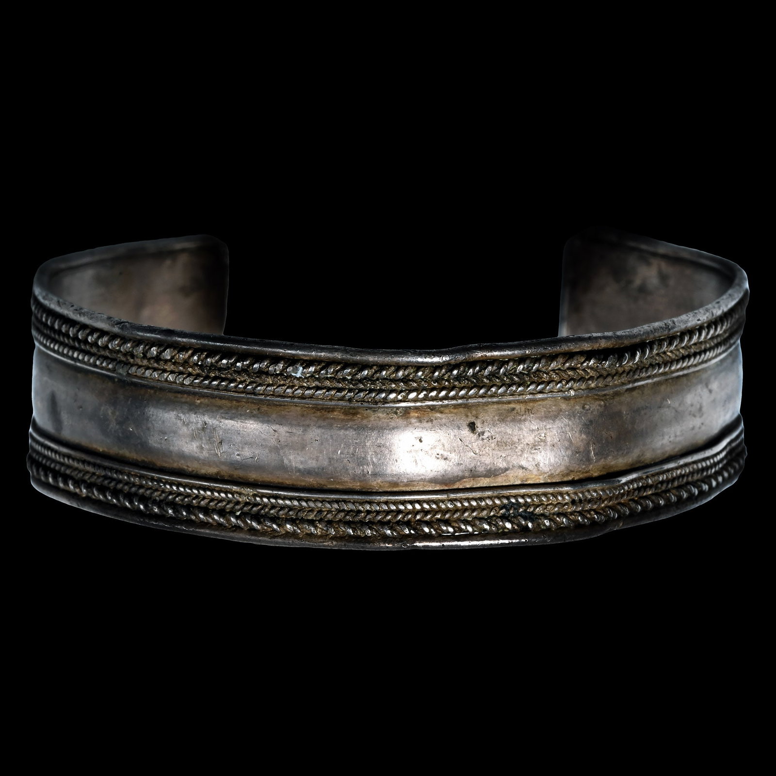 Roman Silver Bracelet with Filigree Wires and Bosses: 1st-4th century A.D. Penannular in plan and rectangular in form with applied bands of filigree ropework to the outer edges, granule to each corner. Cf. Ruseva-Slokoska, L., Roman Jewellery, Sofia, 199